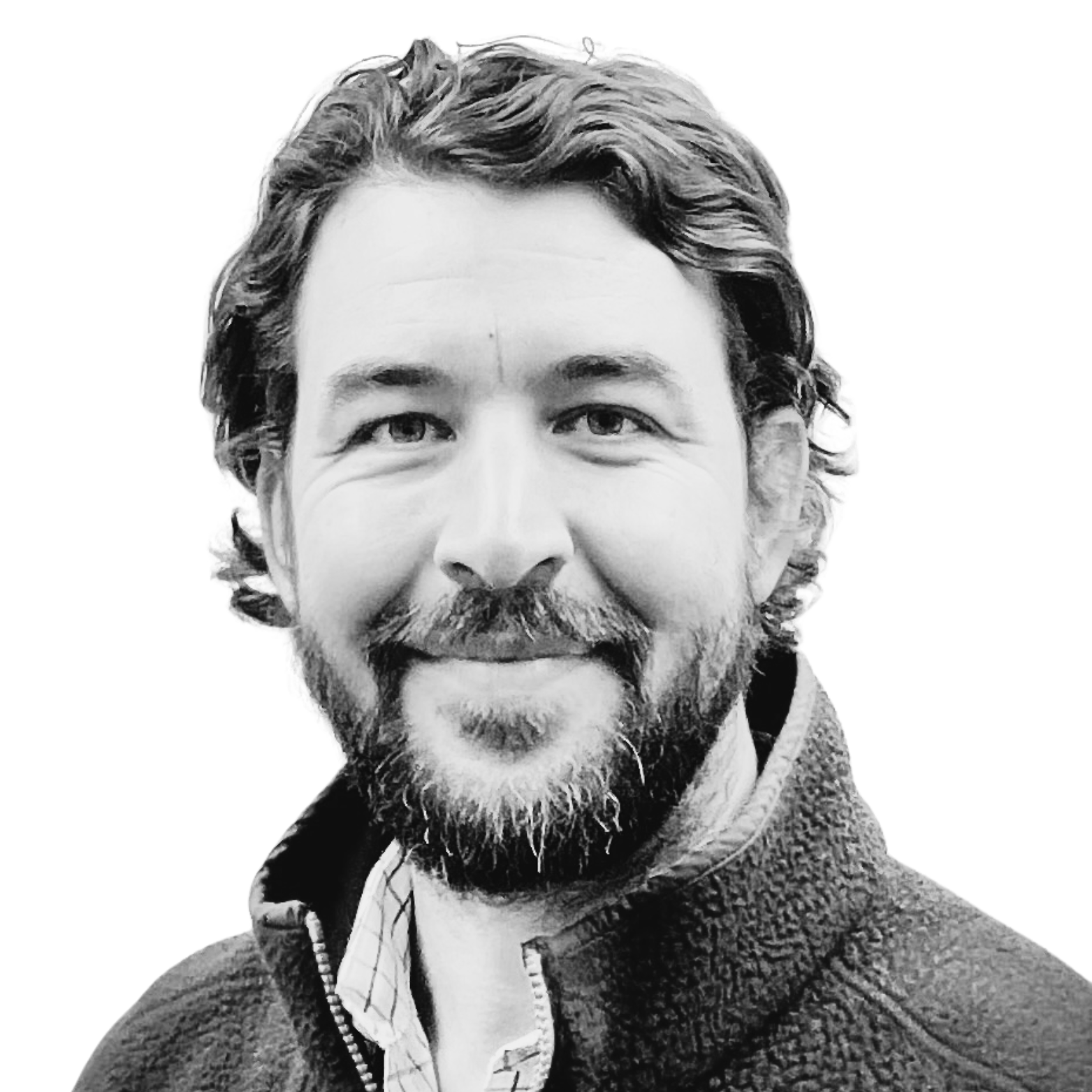 Black and white portrait of a smiling man named Mason Wooldridge with wavy hair and a beard, wearing a textured jacket and a collared shirt.