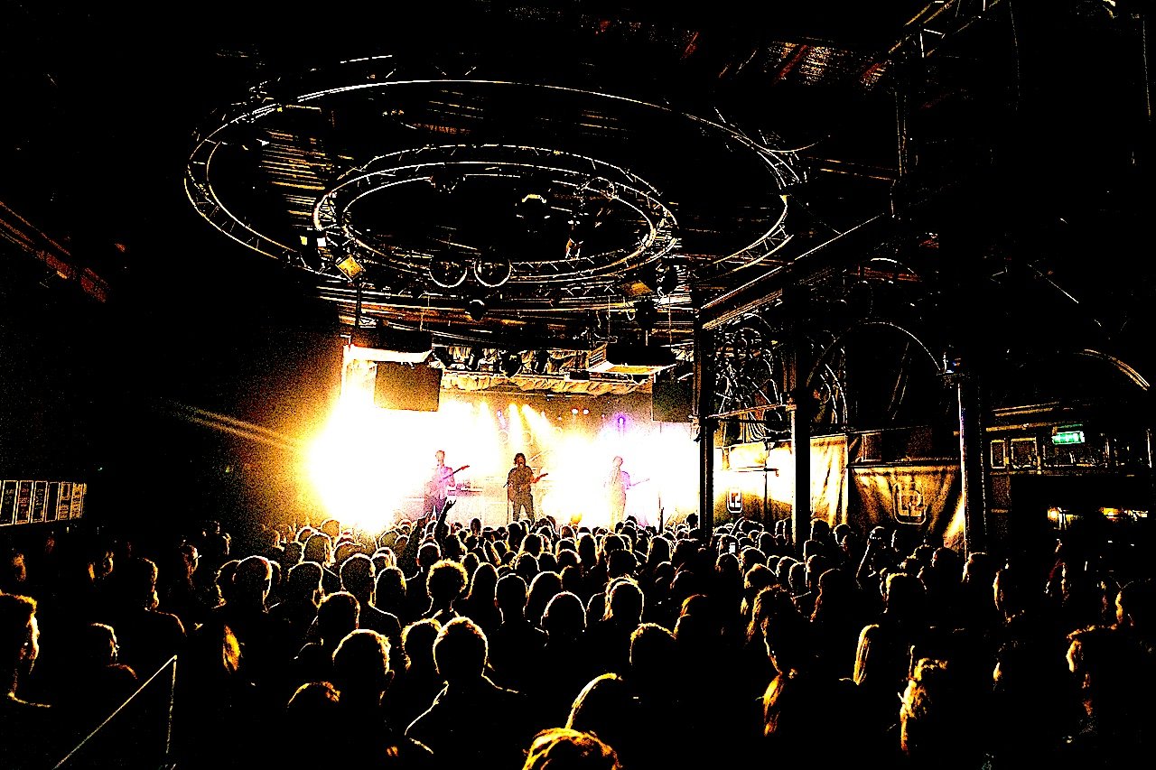 Live band performing to a packed crowd inside an independent live music venue