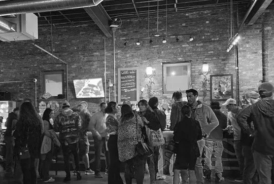 People socialising inside an independent live music venue bar
