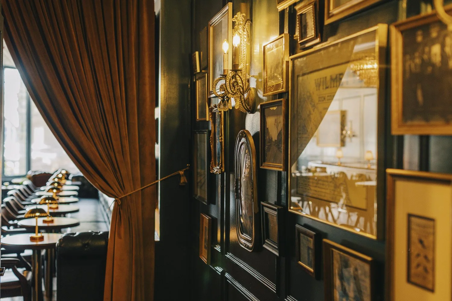 Historic Wilmette gallery wall with vintage sconces and panel moulding