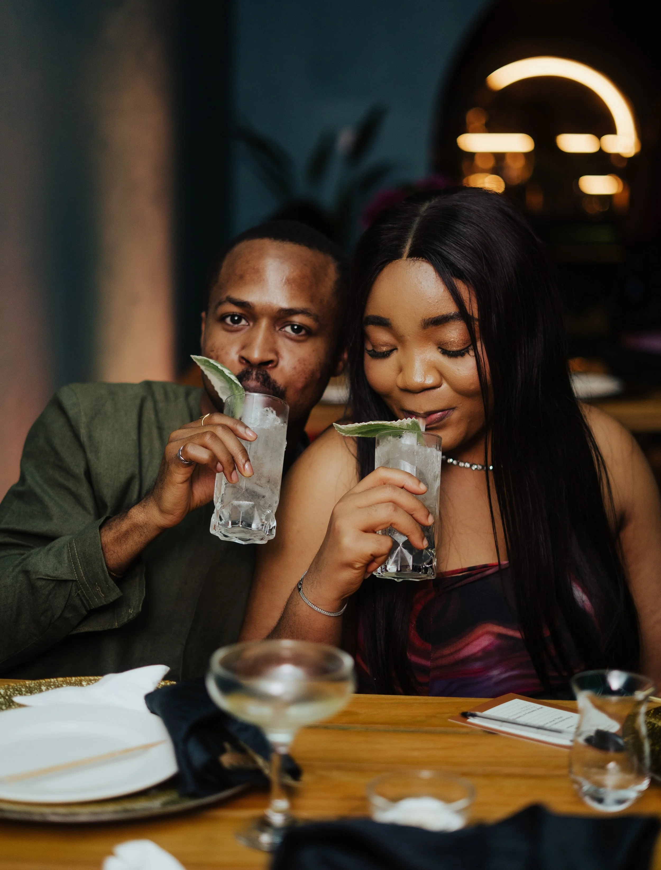 Two friends, a guy and a girl,  enjoying botanical cocktails at an Apotheca Tasting Notes event.