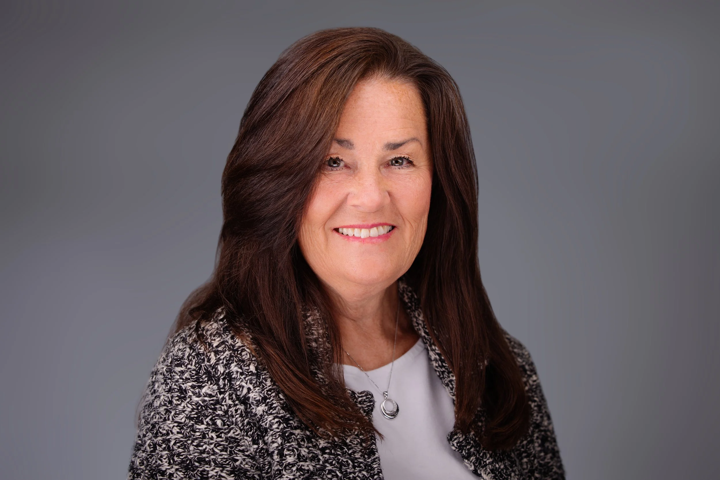 A woman owner of an insurance gets an updated headshot for her website 
