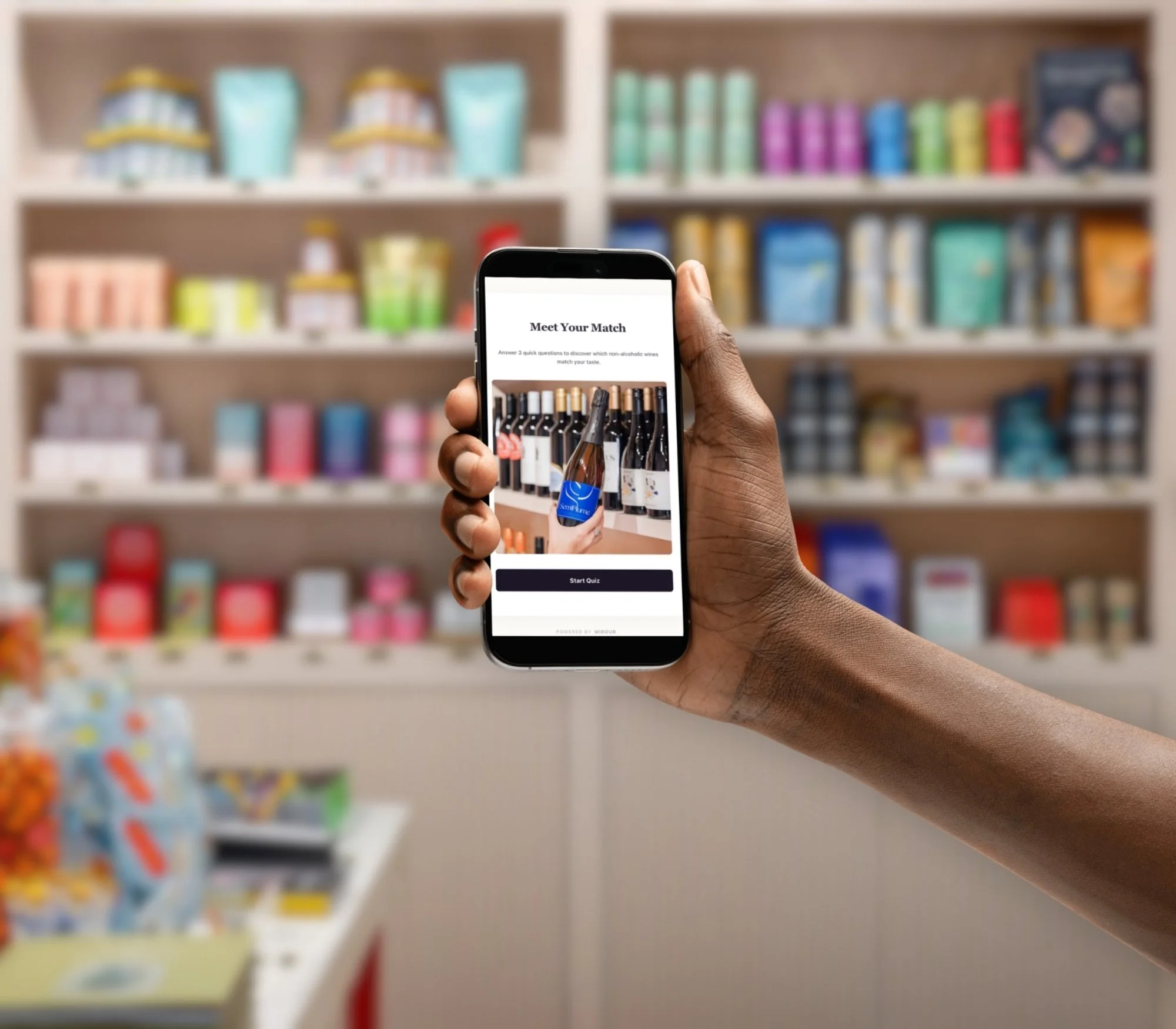 Person holding a smartphone displaying a wine quiz app in front of store shelves with beverages.