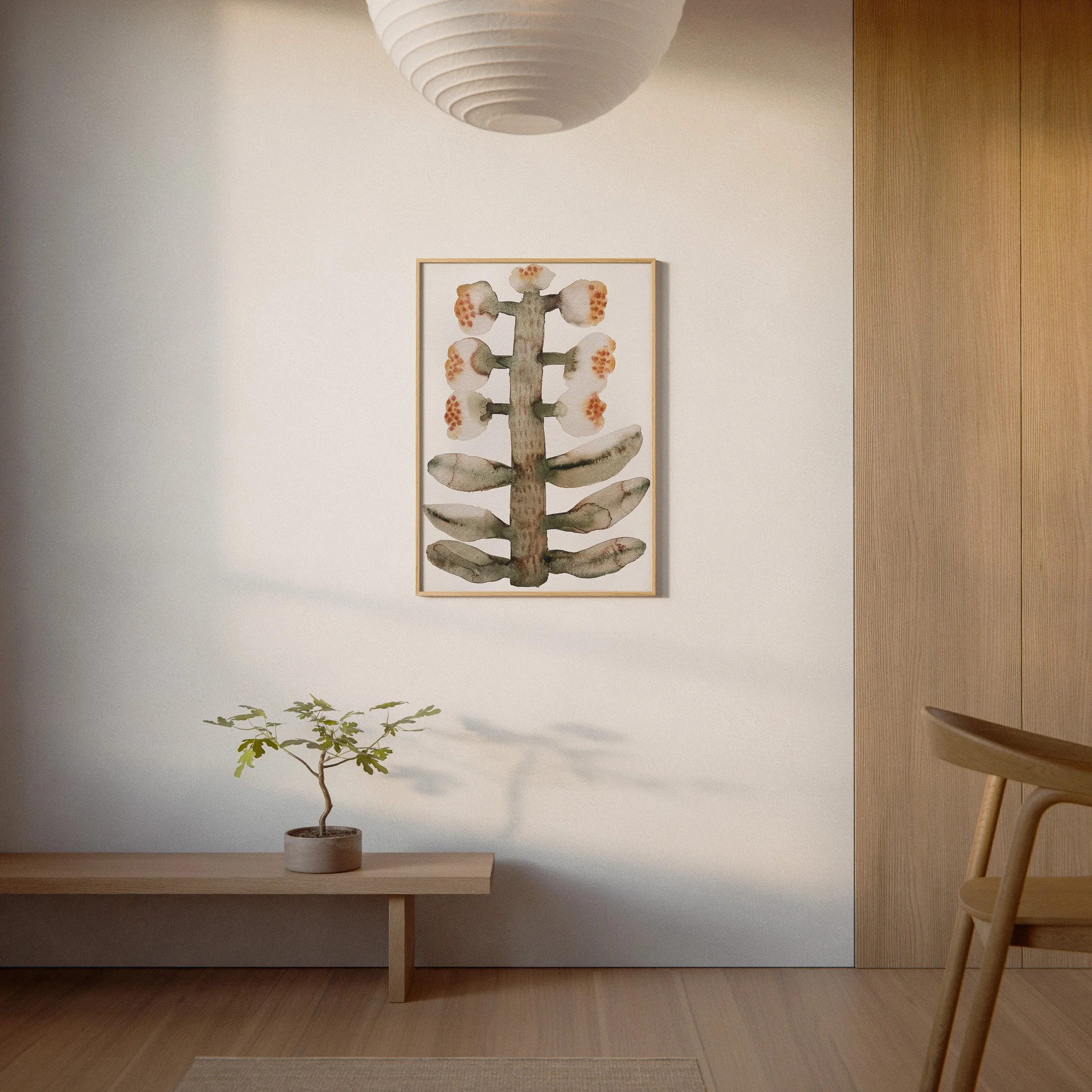 A minimalistic interior scene featuring a small potted plant on a wooden table, framed artwork of a cactus on the wall, a white paper lantern ceiling light, and wooden paneling on the right side. The room has a neutral color scheme with soft lighting.
