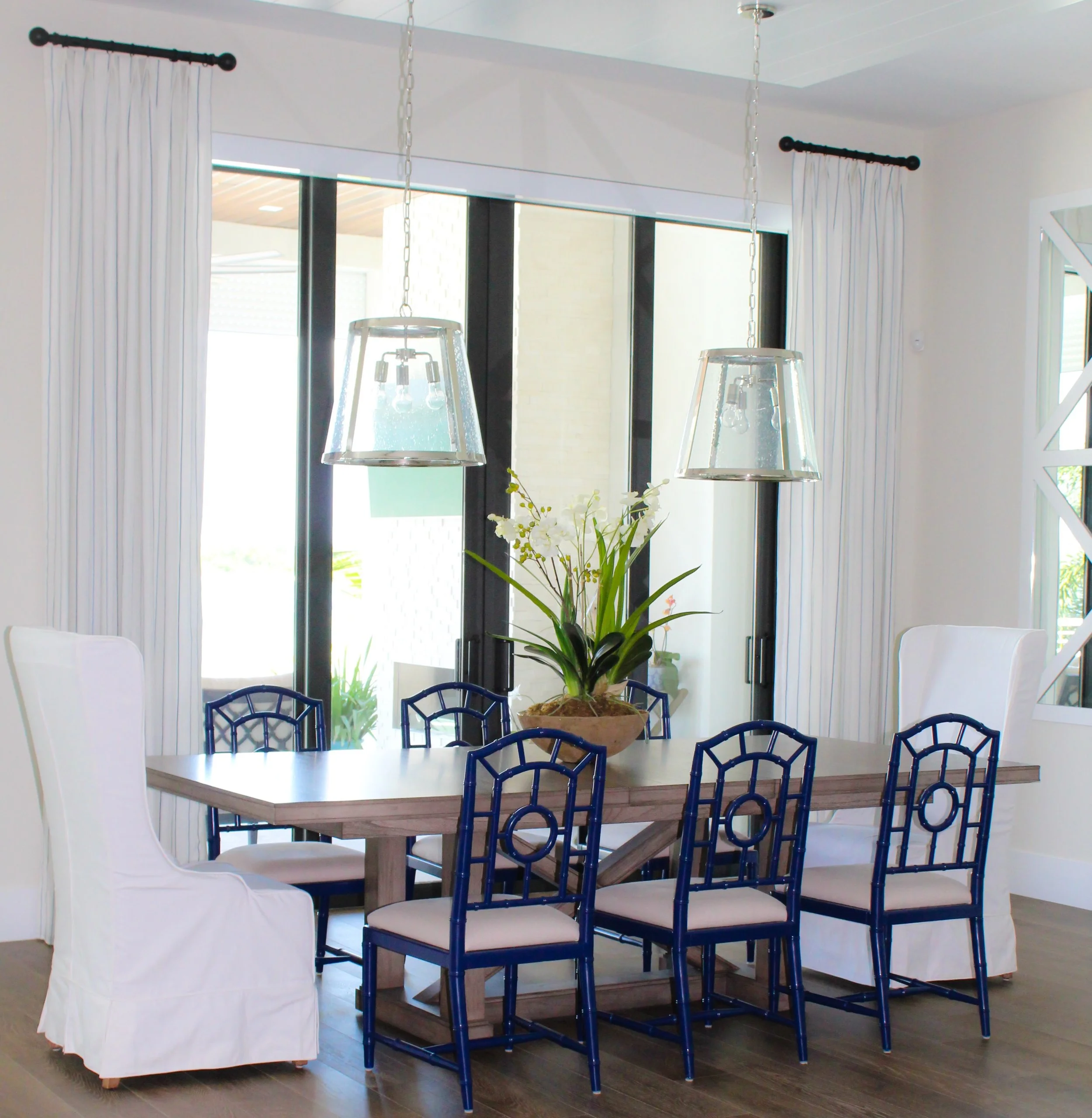 Interior of a finished and furnished dining room with a sliding glass door.