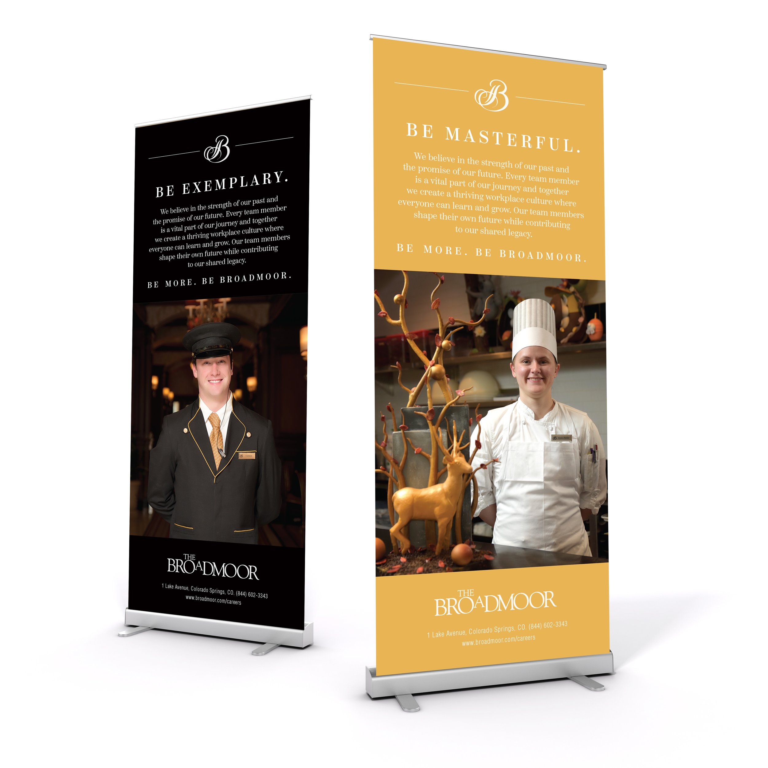 Two standing banners promoting The Broadmoor hotel, featuring staff members in professional attire. One banner has a gold background with the phrase 'Be Masterful' and a chef. The other has a black background with the phrase 'Be Exemplary' and a unif