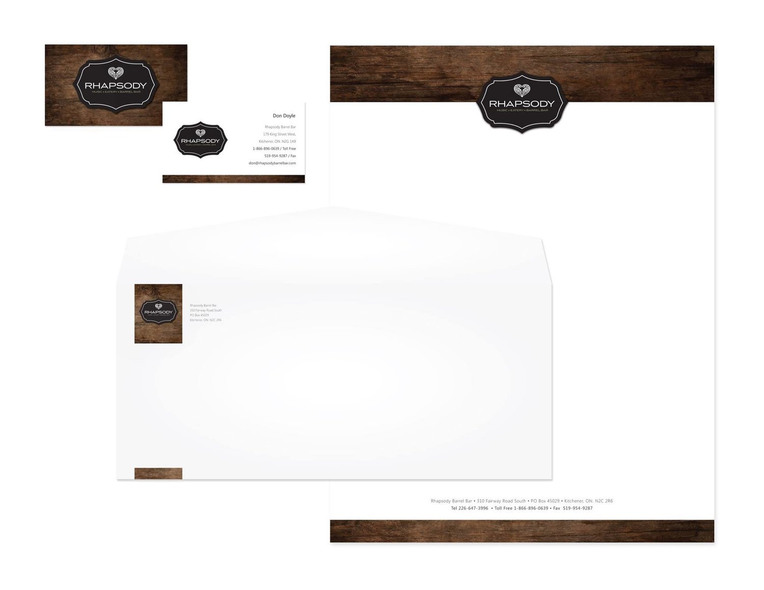 Elegant stationery set with rustic design for Rhapsody, including letterhead, envelope, and business card, featuring dark wood texture and logo.