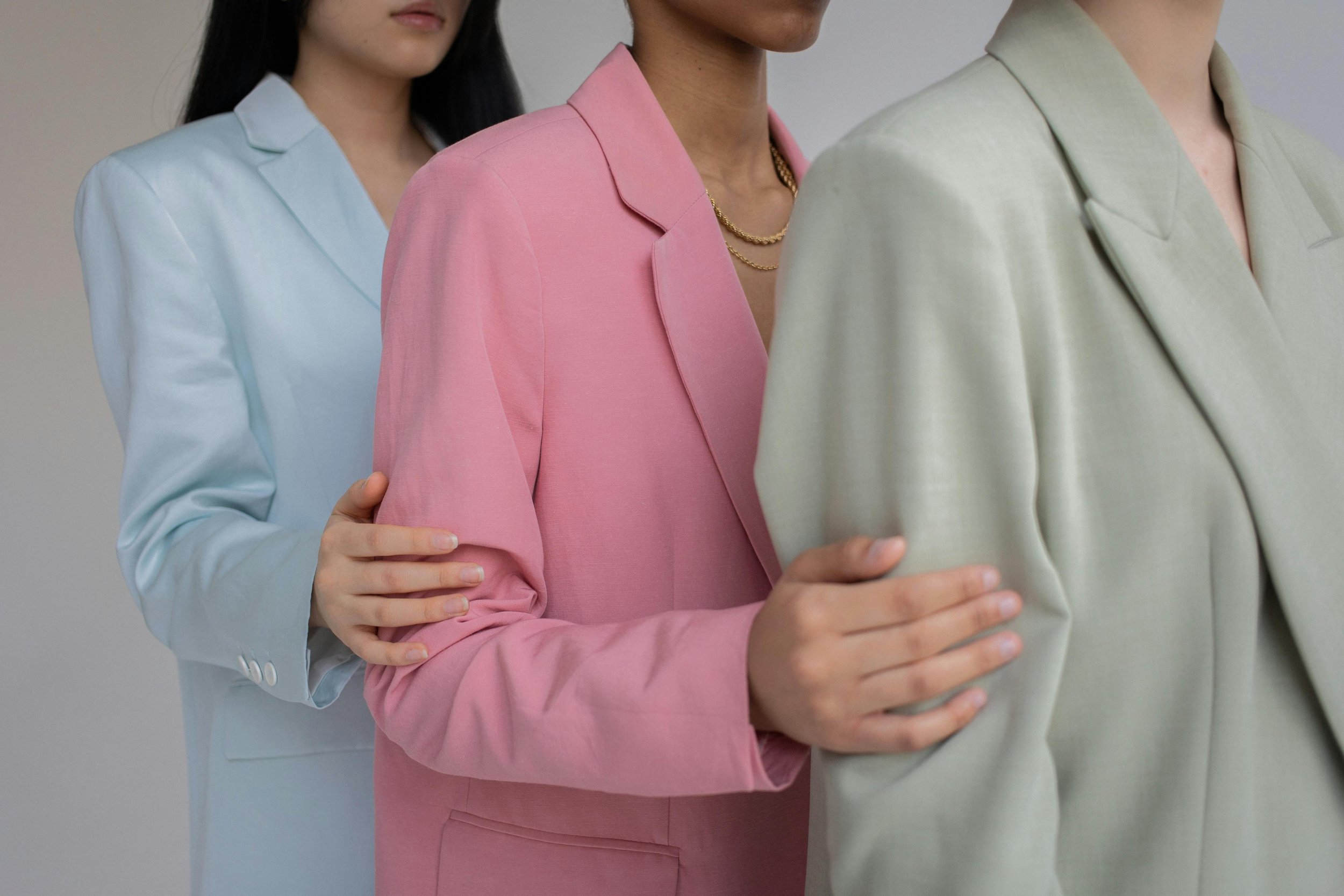 3 girls in pastel color suits