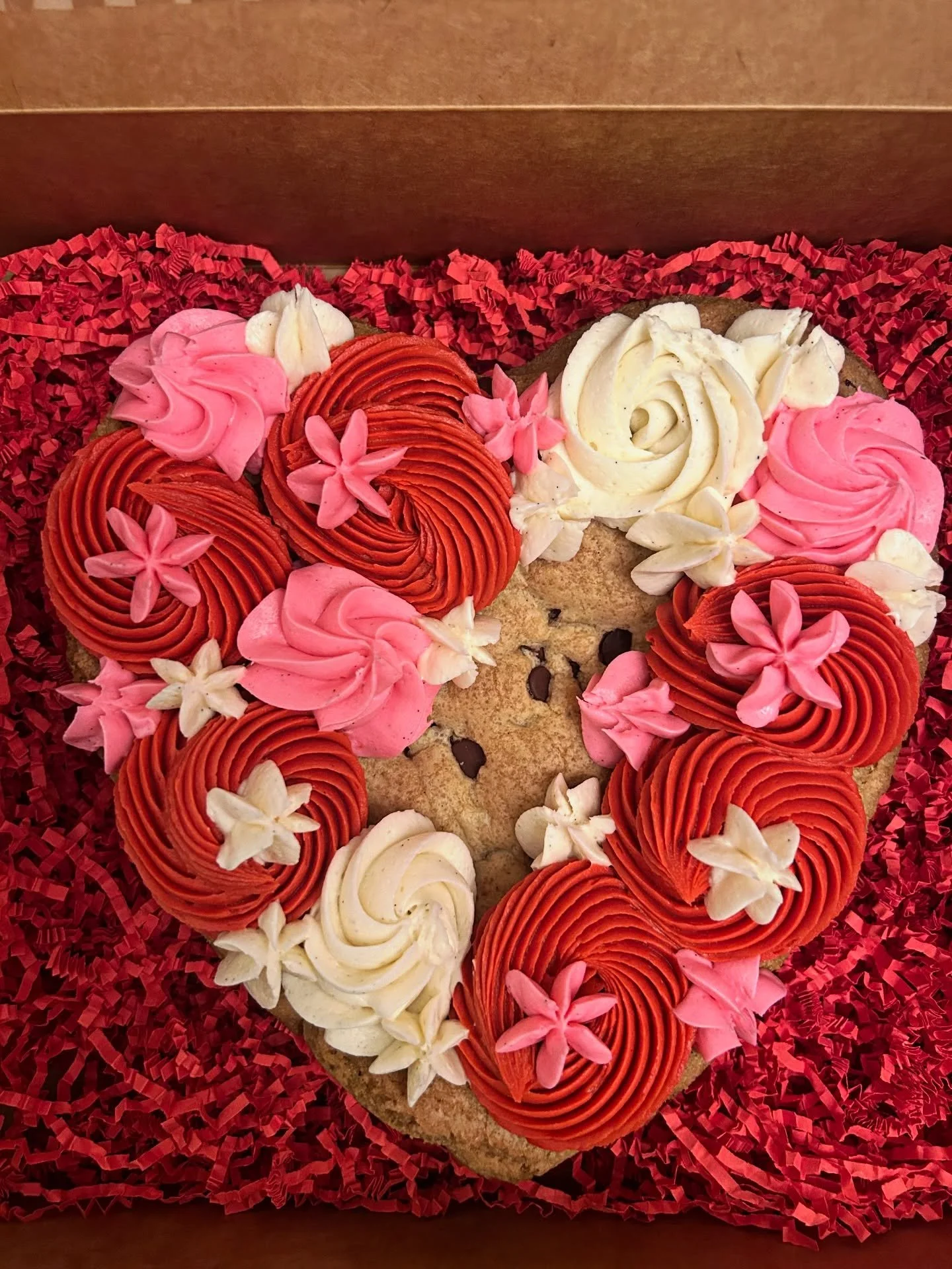 Skip the dozen roses.
Get the cookie cake. ❤️

Heart-shaped, chewy, and covered in buttercream swirls.