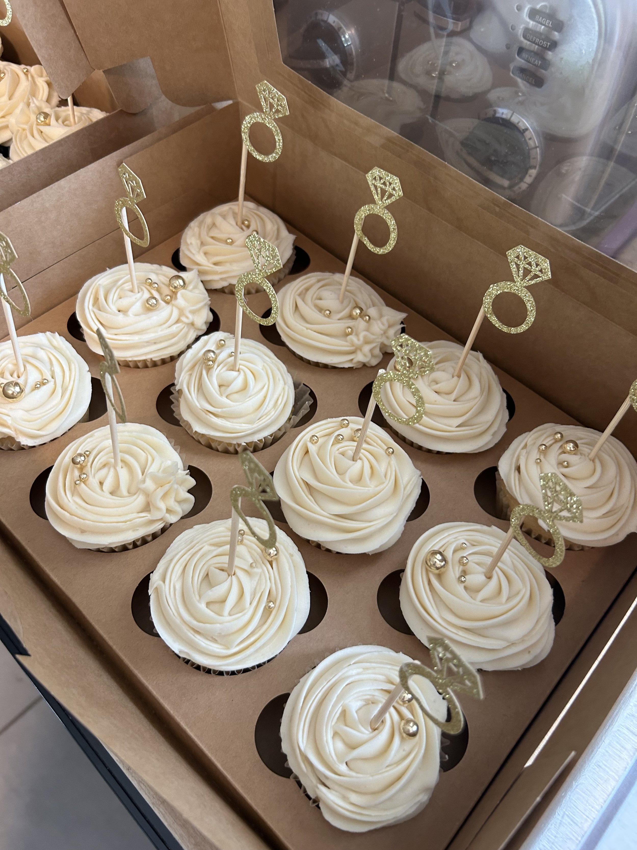 Vanilla cupcakes made for an engagement party by The Storybook Kitchen.