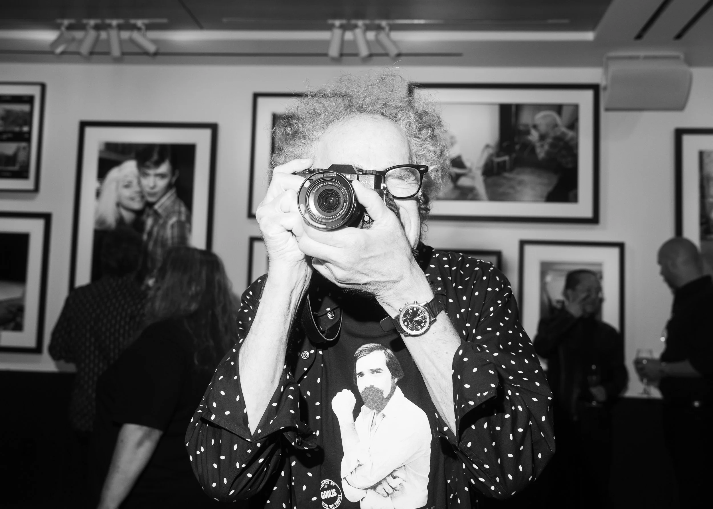 Man holding up a camera to take a photo.