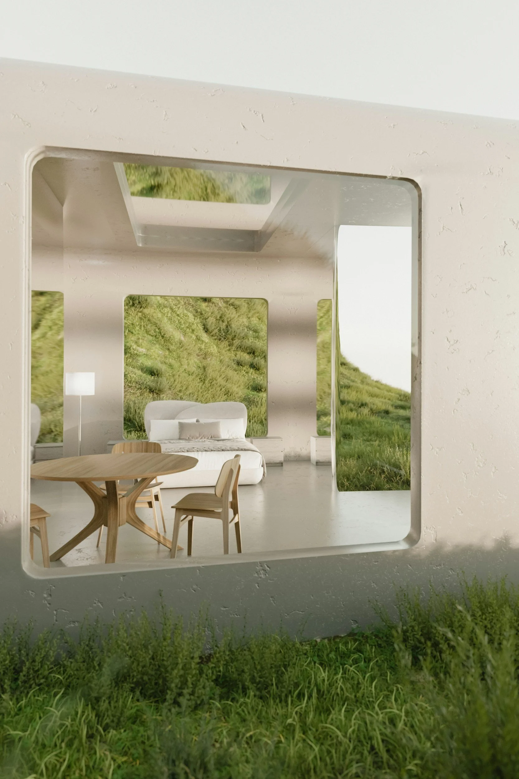Interior view of a modern house with a large window showing a grassy hillside outside, featuring a round wooden dining table with chairs, a white sofa, a standing lamp, and a landscape mural on the wall.