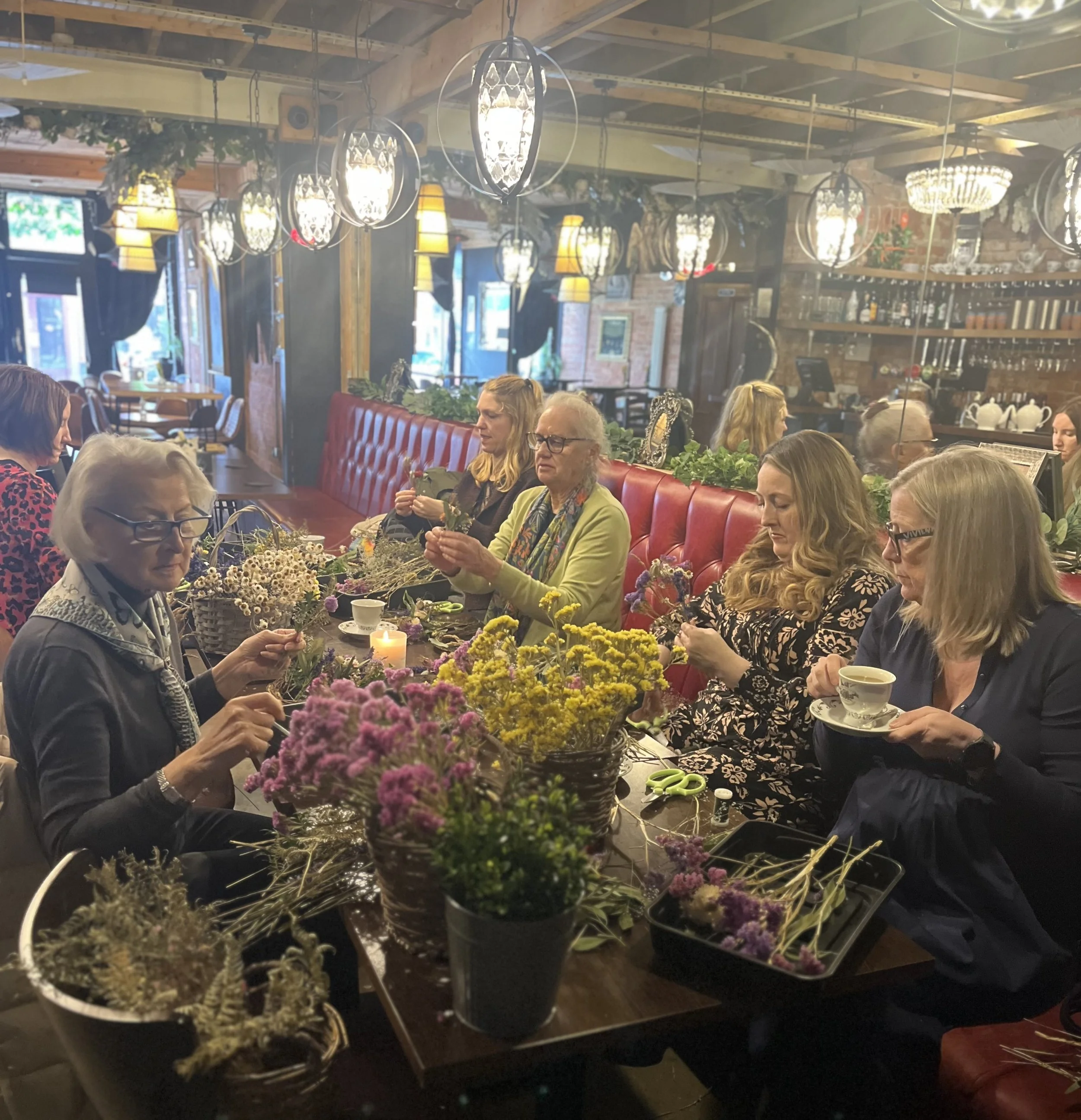 Attendees enjoying a festive Christmas wreath and floral workshop inside Angel Bar in Caversham, Reading