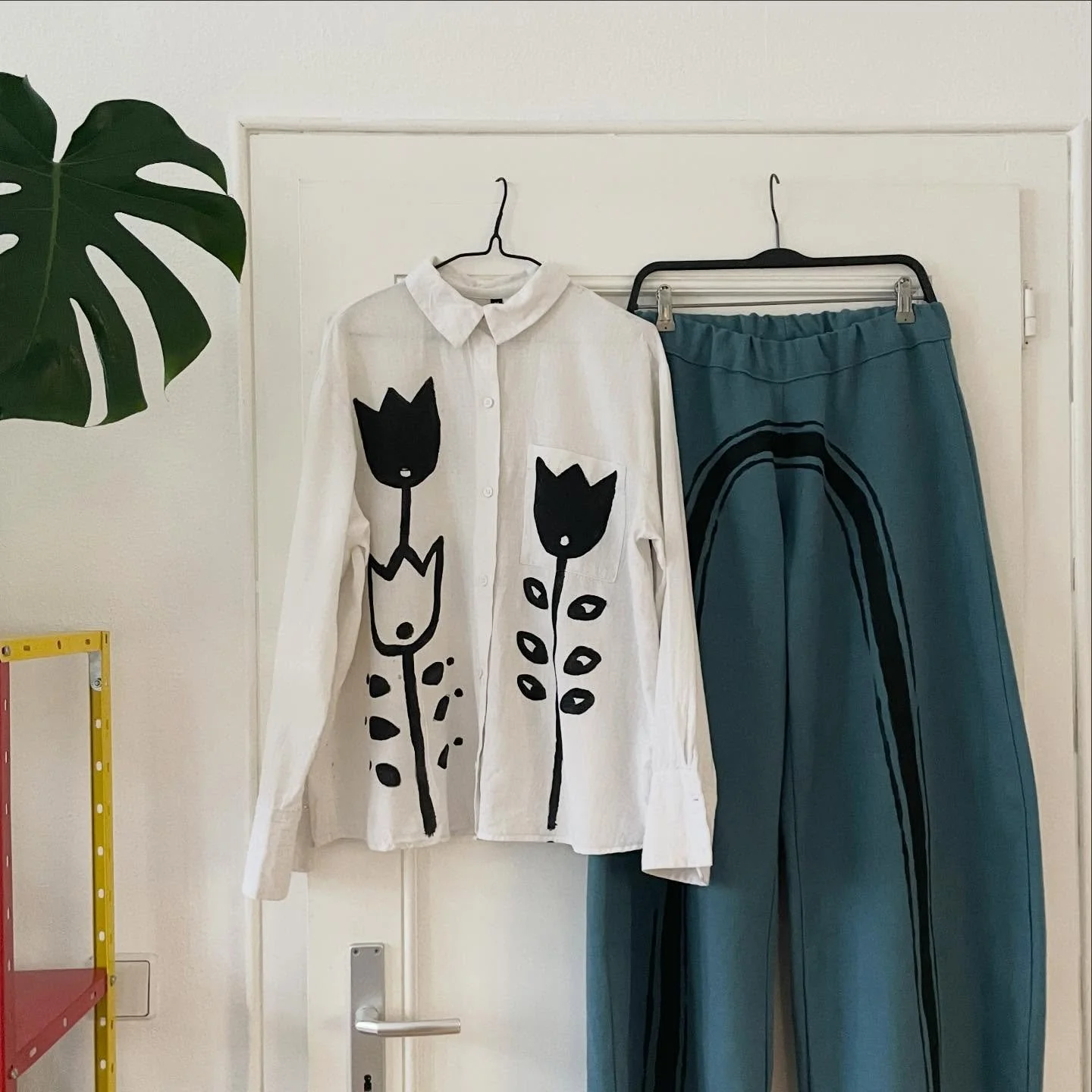 a shirt i painted on and a pair of pants i made and then painted on but they exist together nicely