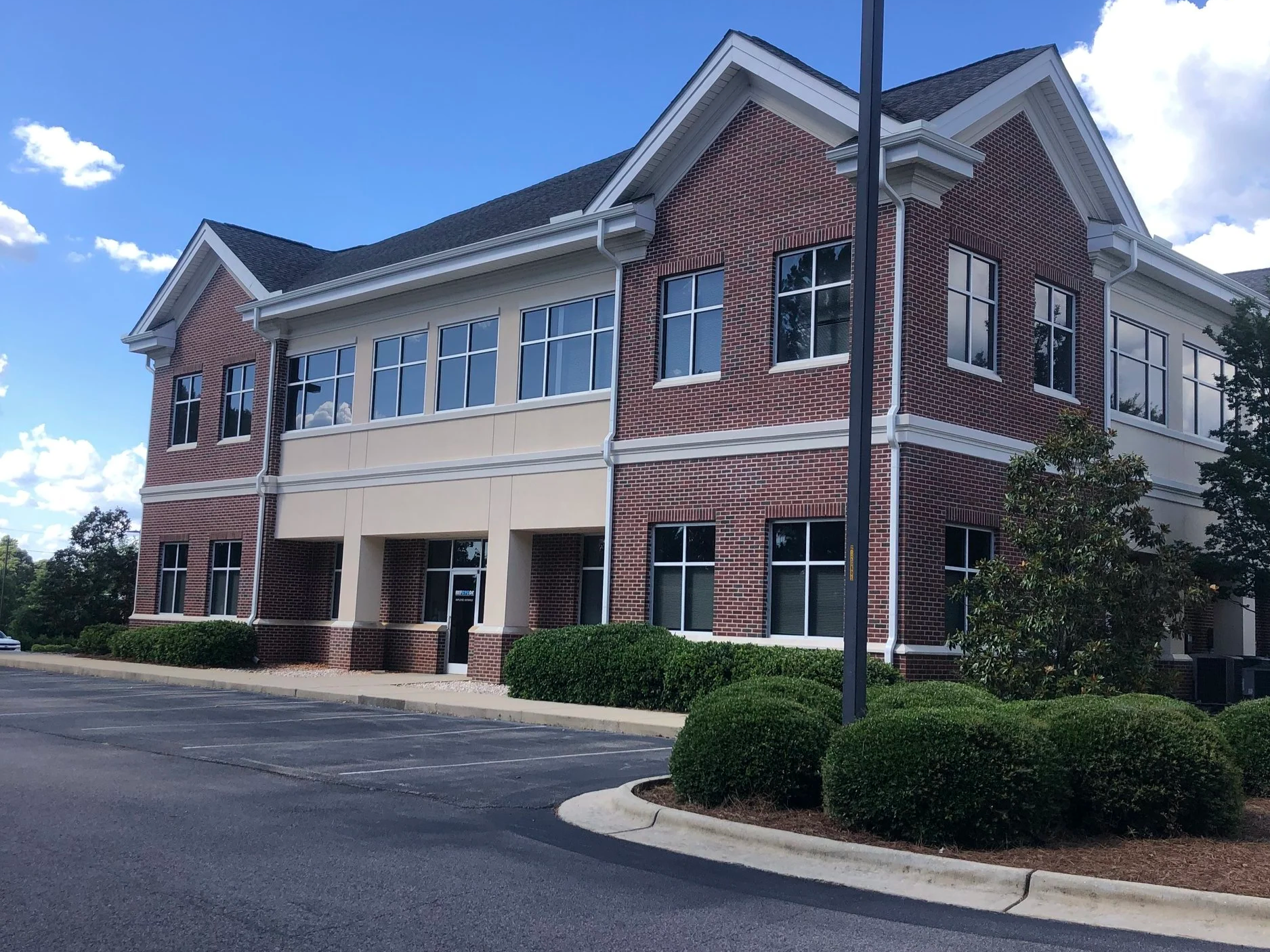 Two story office building, full-scale pressure washing and stucco repainting