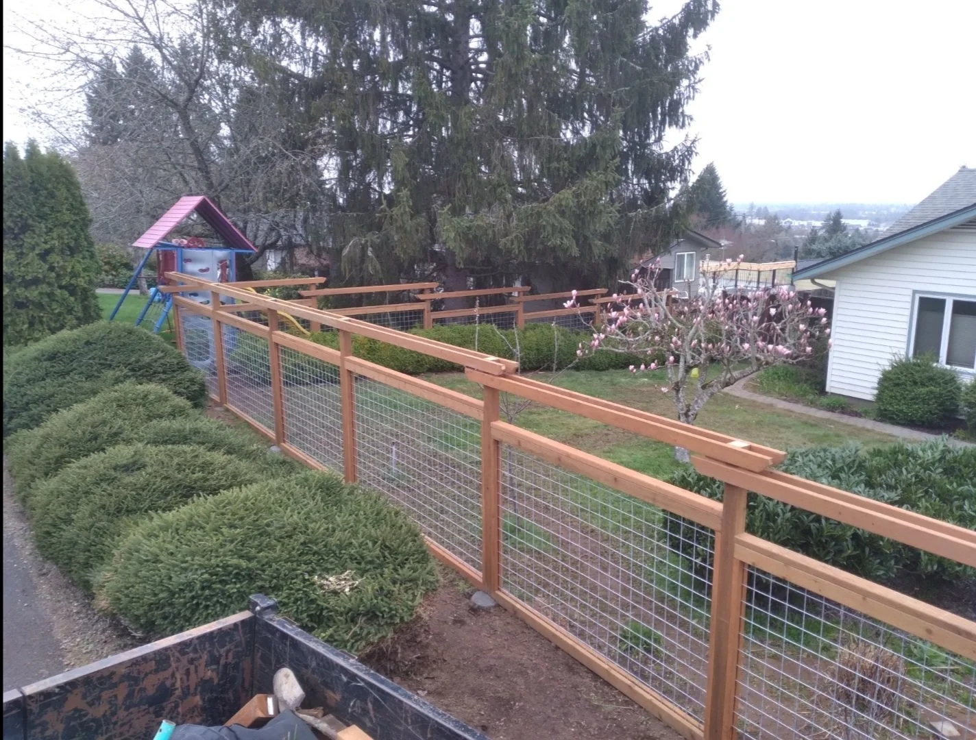 Wood-and-wire fence blends visibility with sturdy, reliable boundaries.