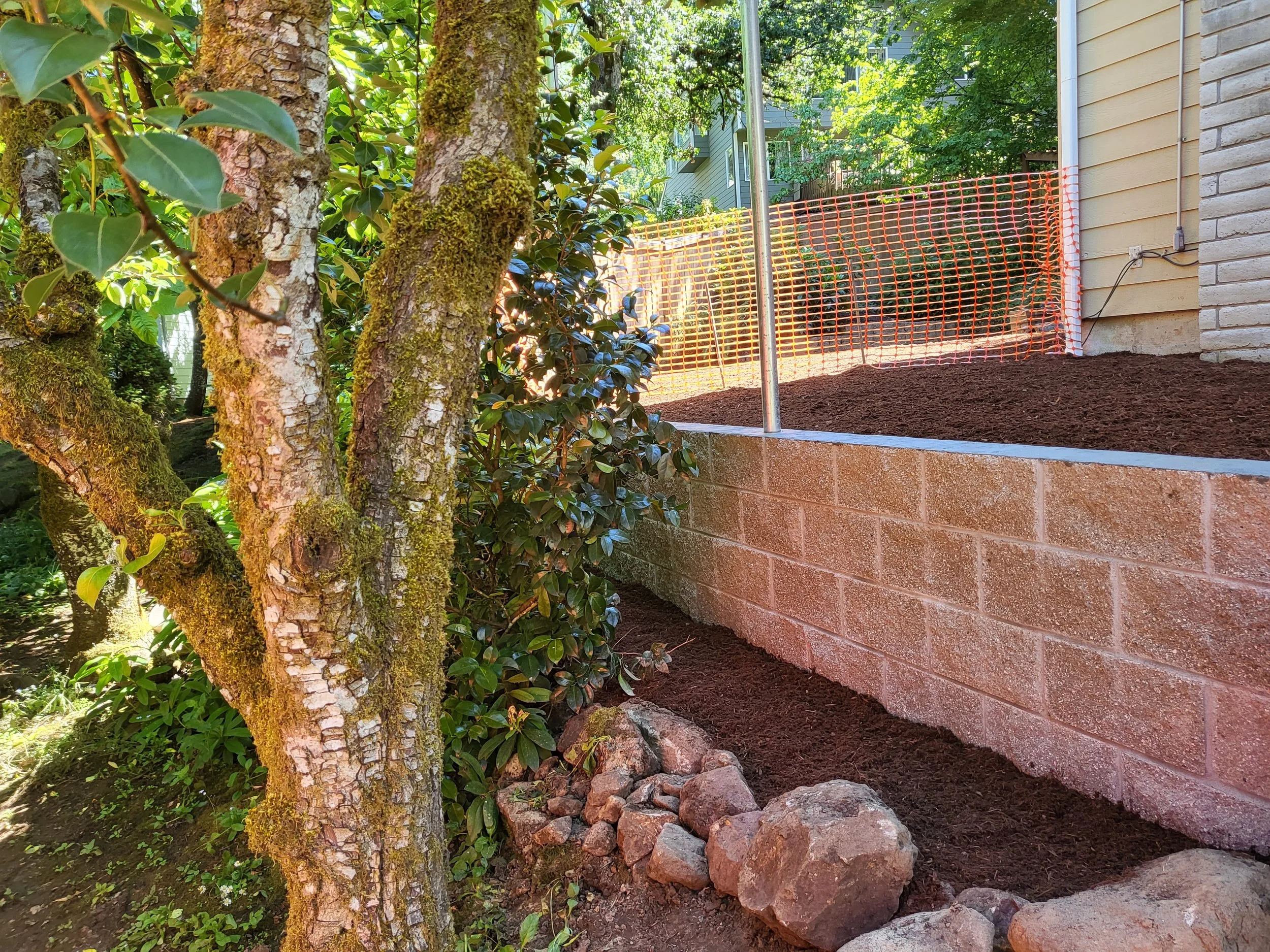 Freshly built retaining wall adding structure, durability, and a clean look to the landscape.