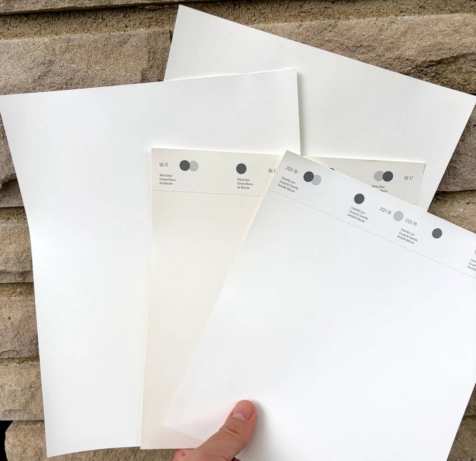 Exterior paint samples against 1950s stone facade white dove, chantilly lace, sherwin williams snow bound