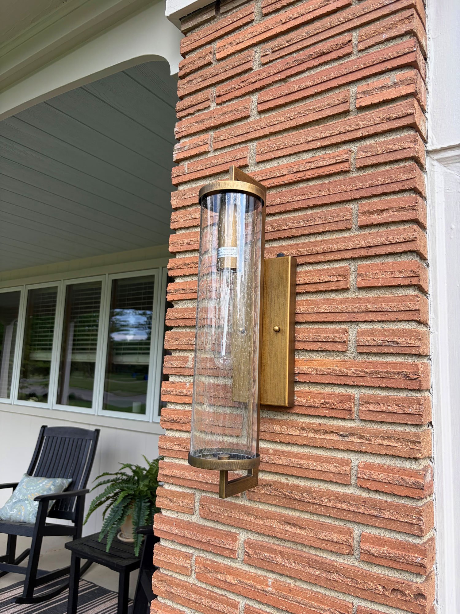 Modern brass exterior sconce mounted on original brick, Columbus home exterior refresh