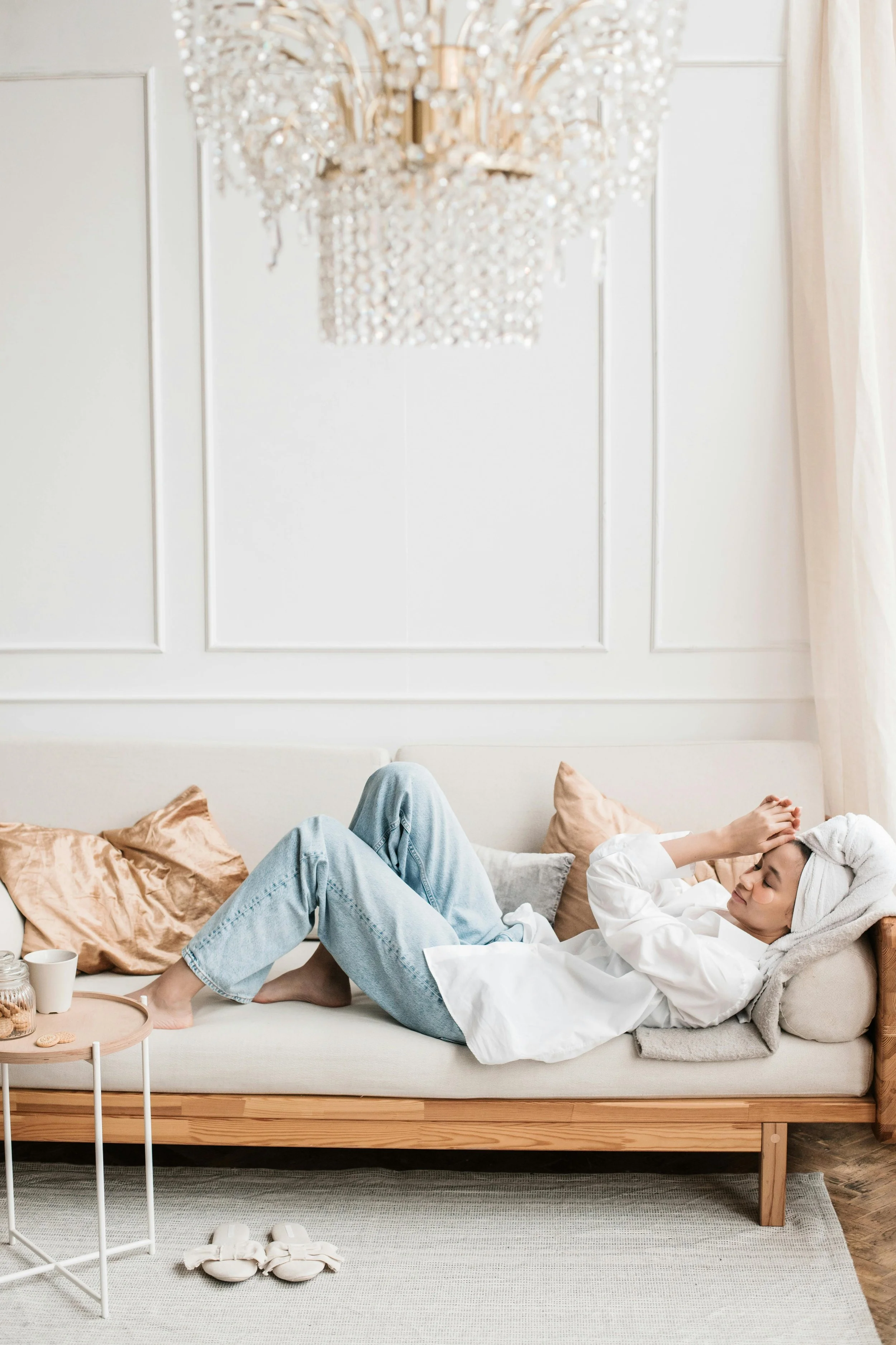 Woman resting on a couch with eyes closed — finally exhaling after anxiety therapy