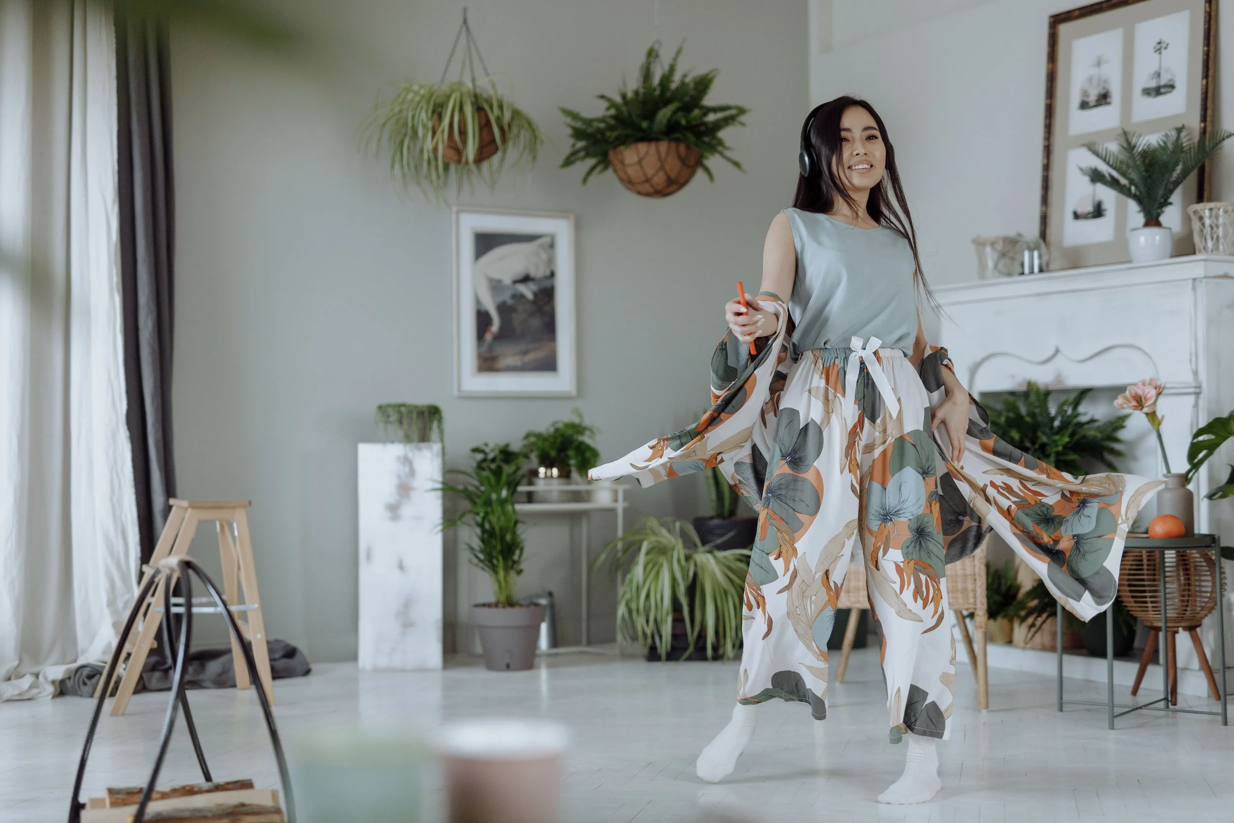 Woman dancing freely in a bright studio representing healing through trauma-informed therapy at Mental Lift