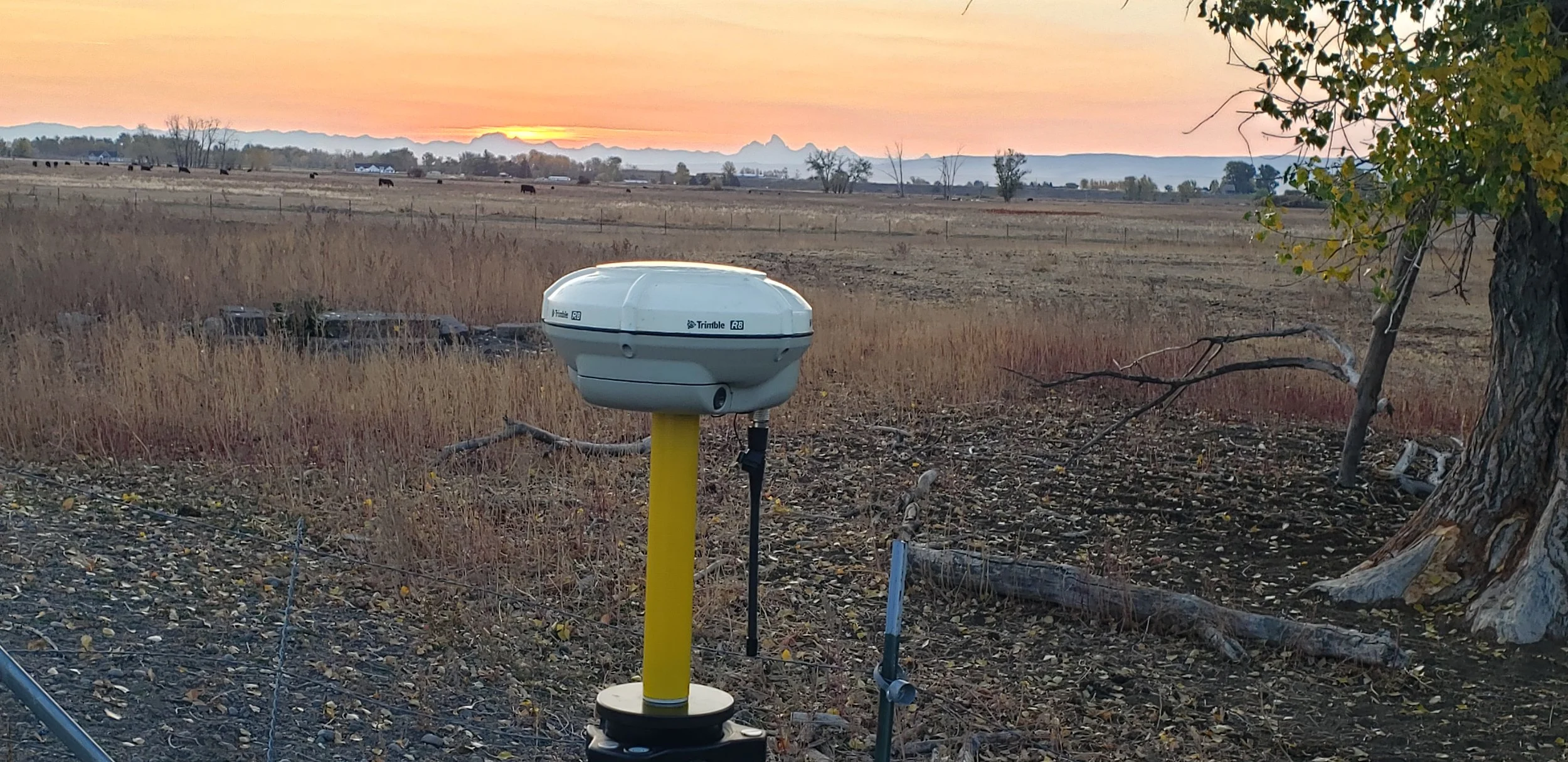 Geodetic Survey Equipment against an sunset background
