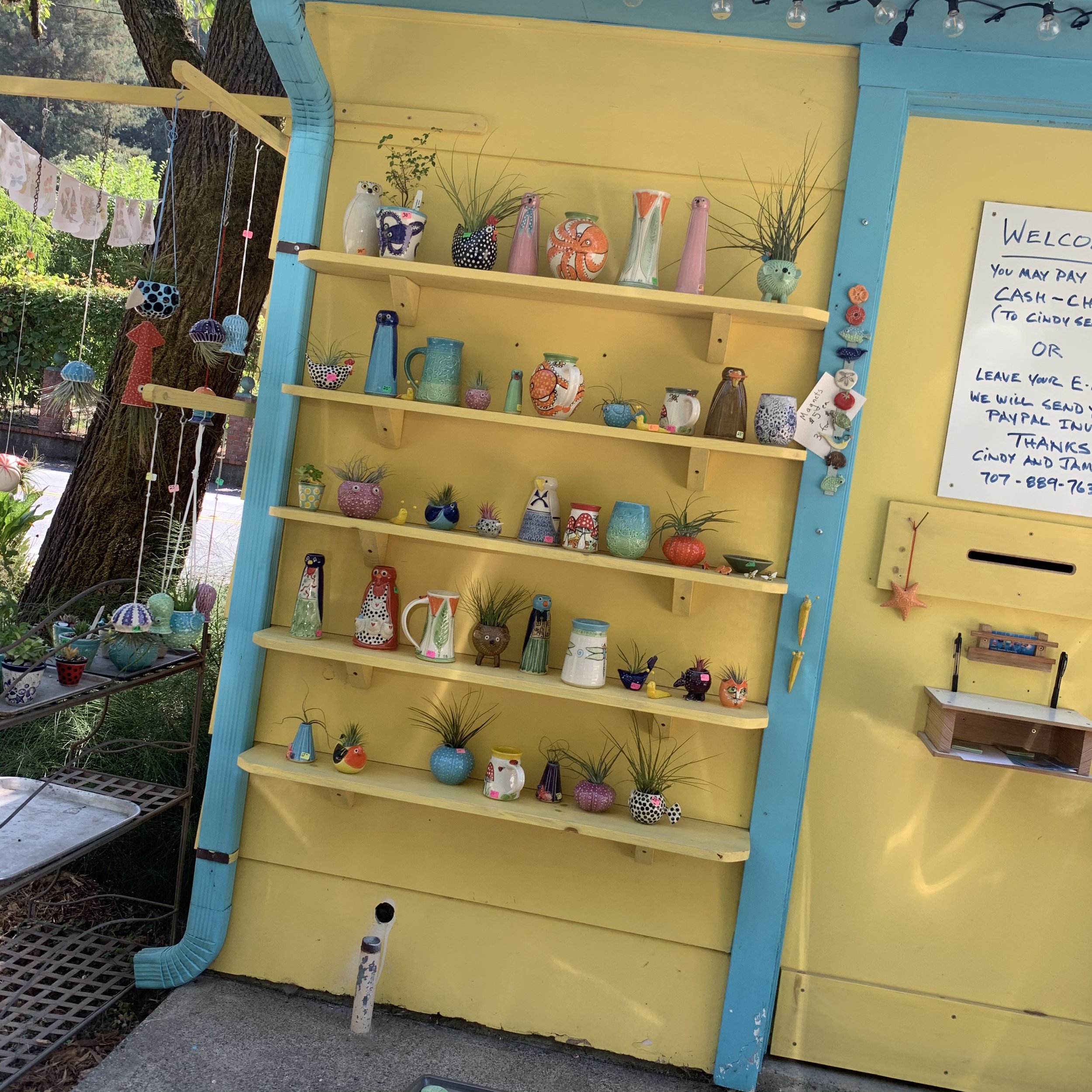 Pottery on shelves at the Drive Through Pottery Stand in Occidental, California