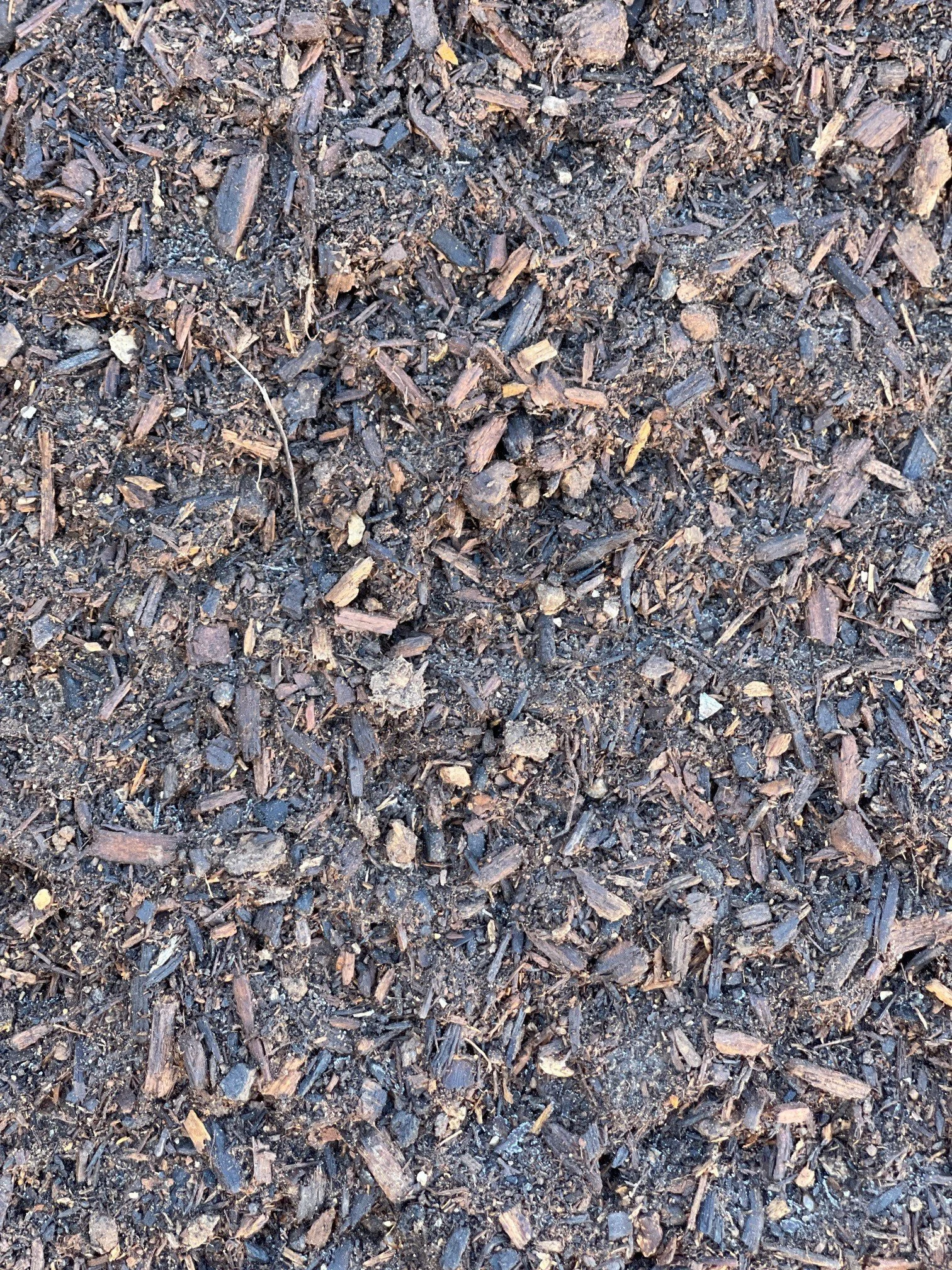 Compost mix enriching planting beds in Colleyville, TX