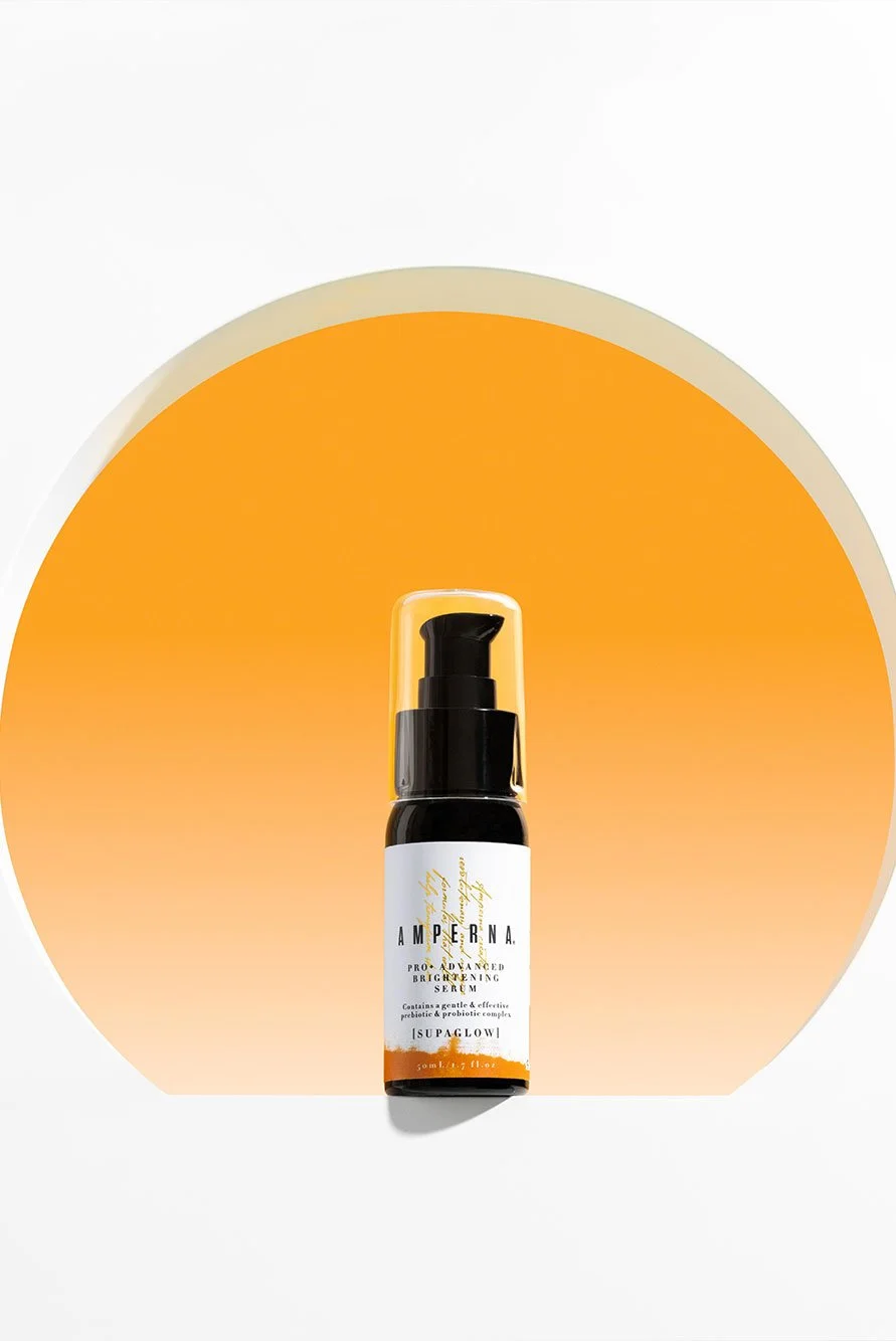 Ampurna skincare product bottle against an orange gradient background