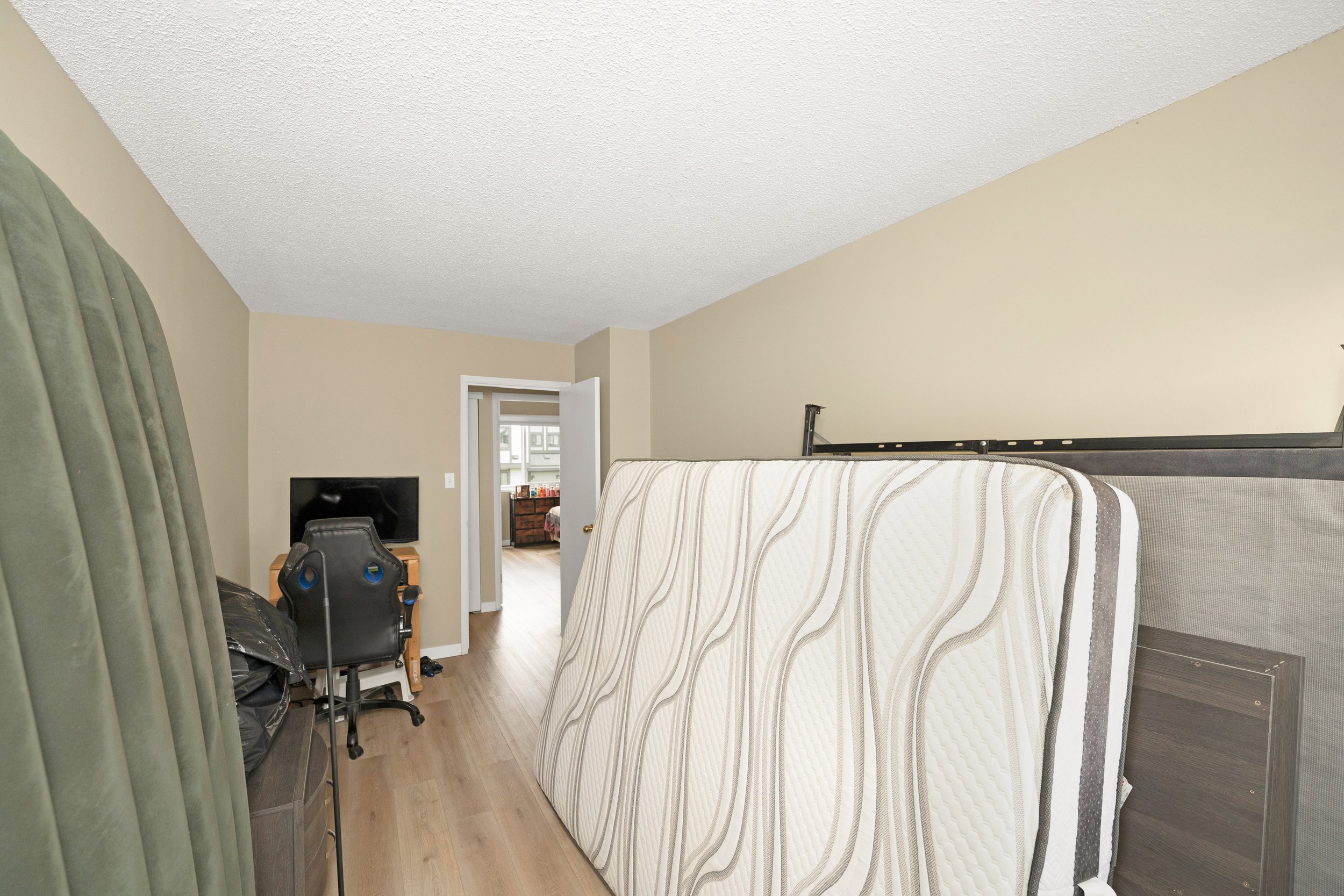 Empty room with a curtain and plain walls.