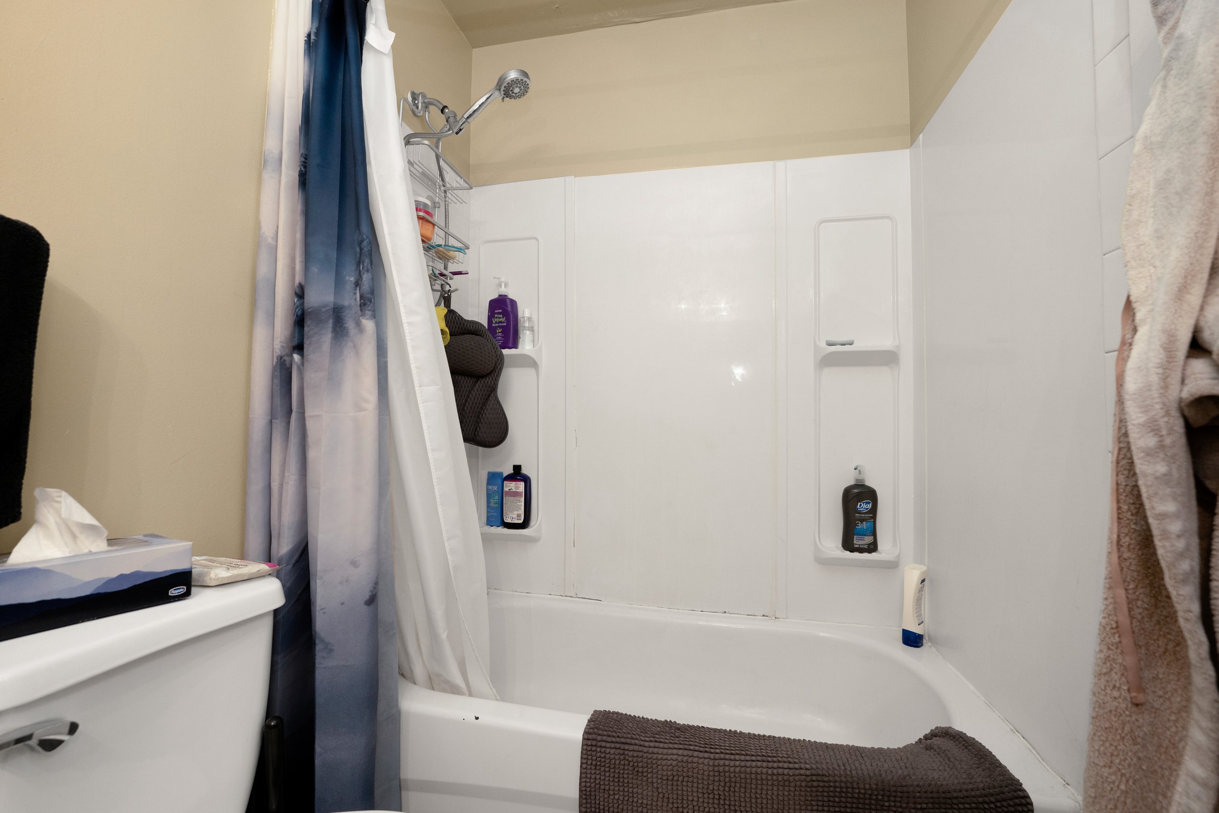 Modern bathroom with a bathtub and shower curtain.