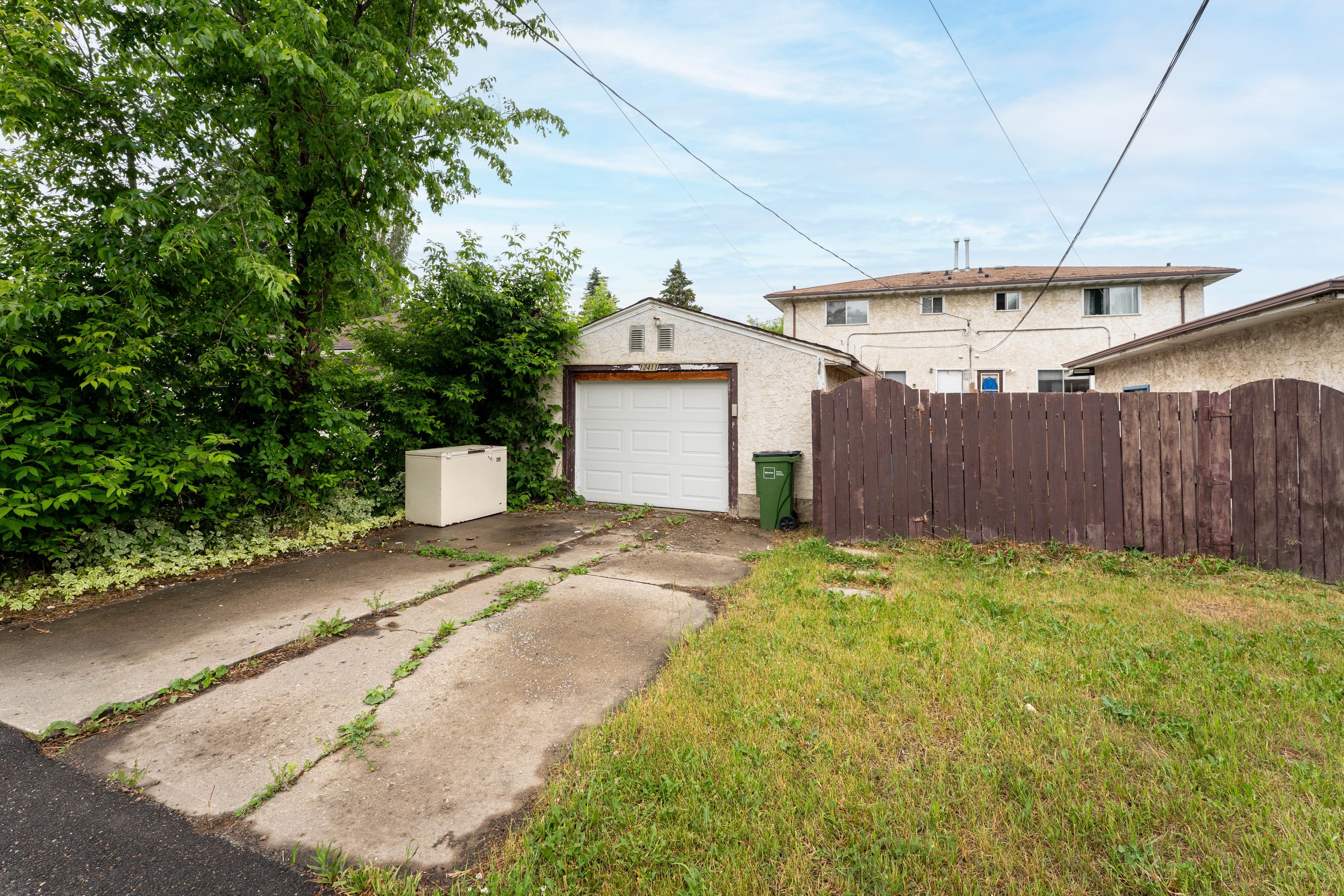 Front yard and pathway of a rent to own property with a welcoming house entrance.