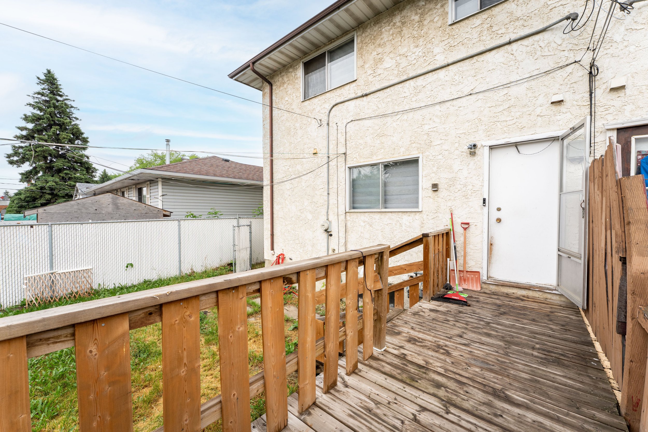 Exterior view of a rent to own house with a fenced yard and driveway.