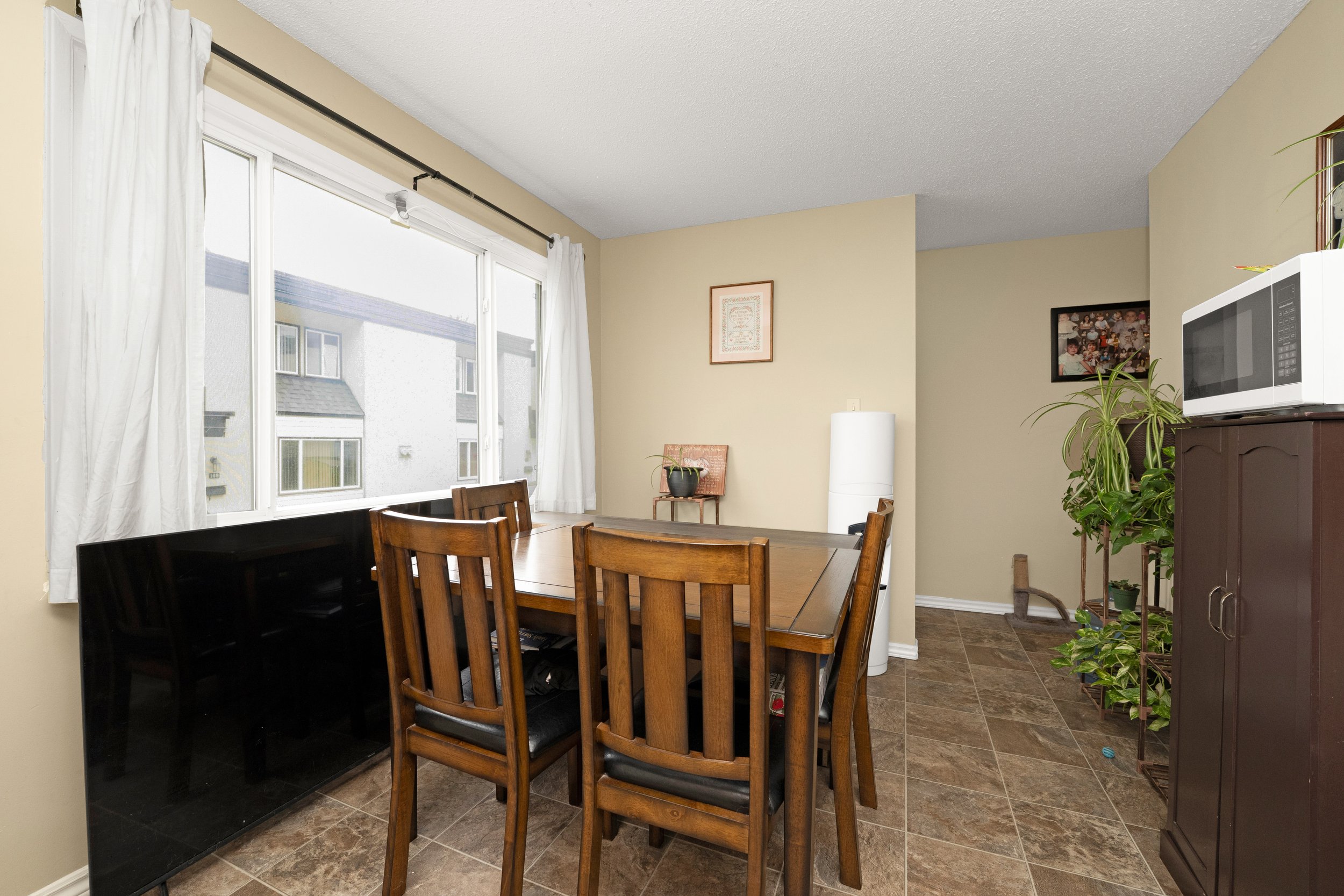 Elegant dining room with wooden furniture and subtle decor.