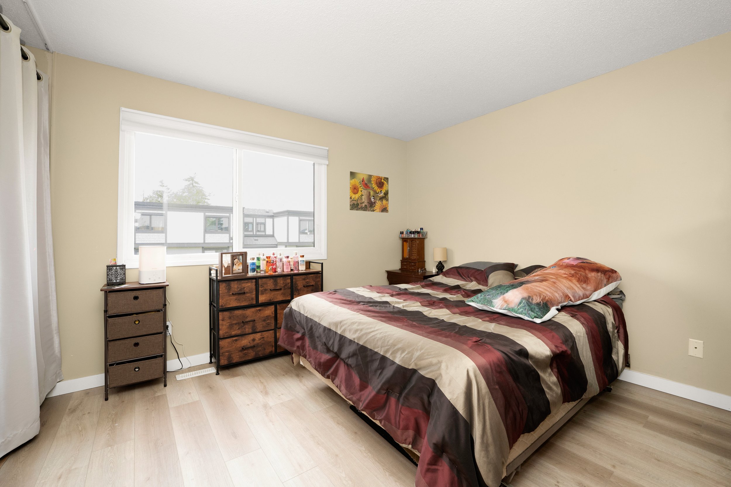 Cozy bedroom with two beds and wooden furniture.