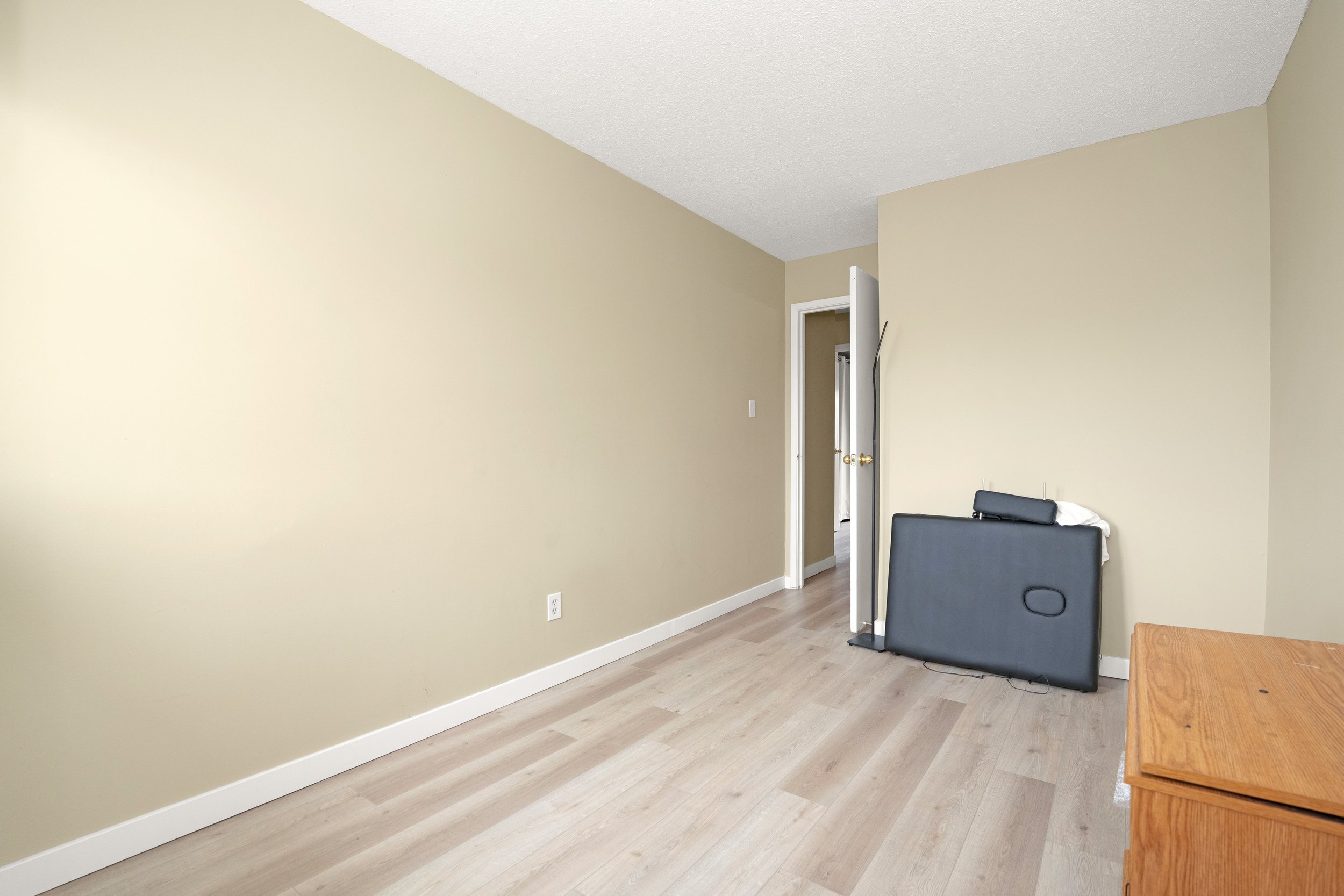 Empty space with a suitcase and neutral walls.