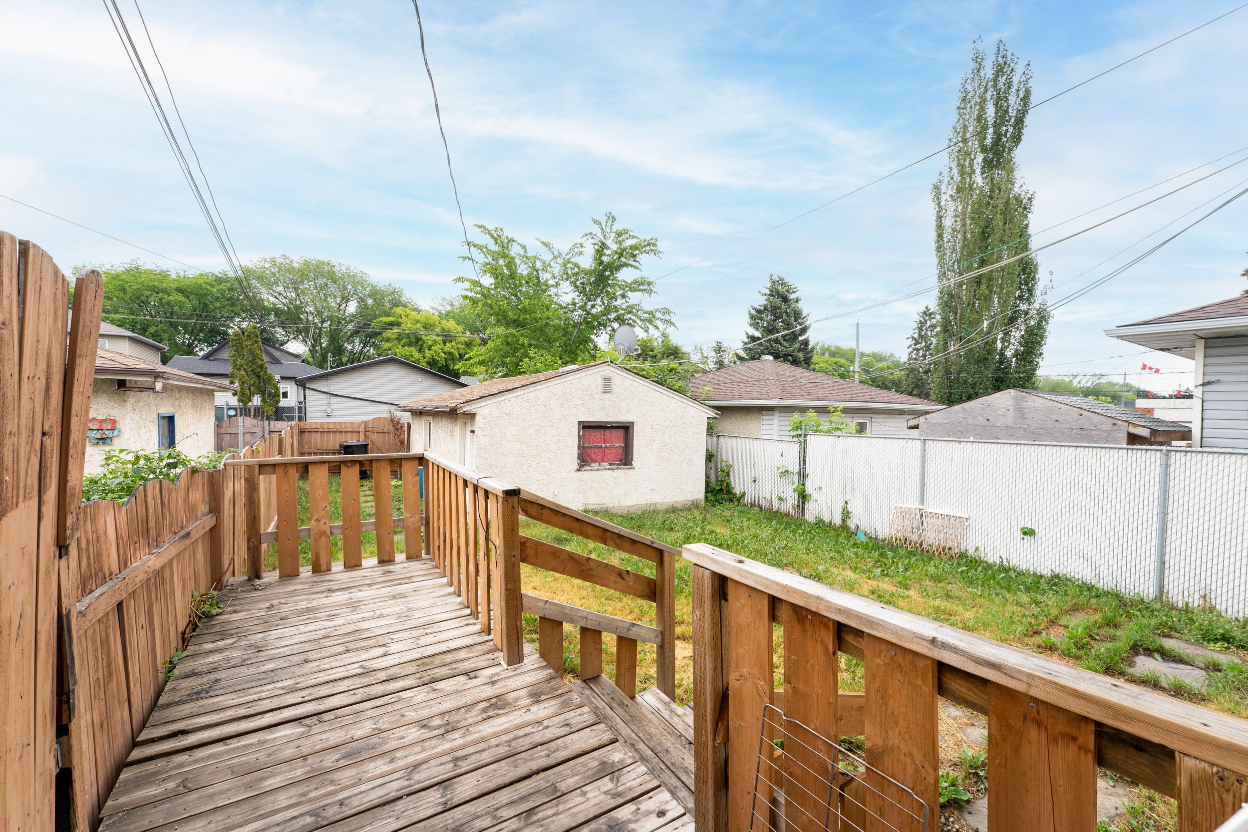 Spacious backyard deck of a rent to own property, perfect for outdoor relaxation.