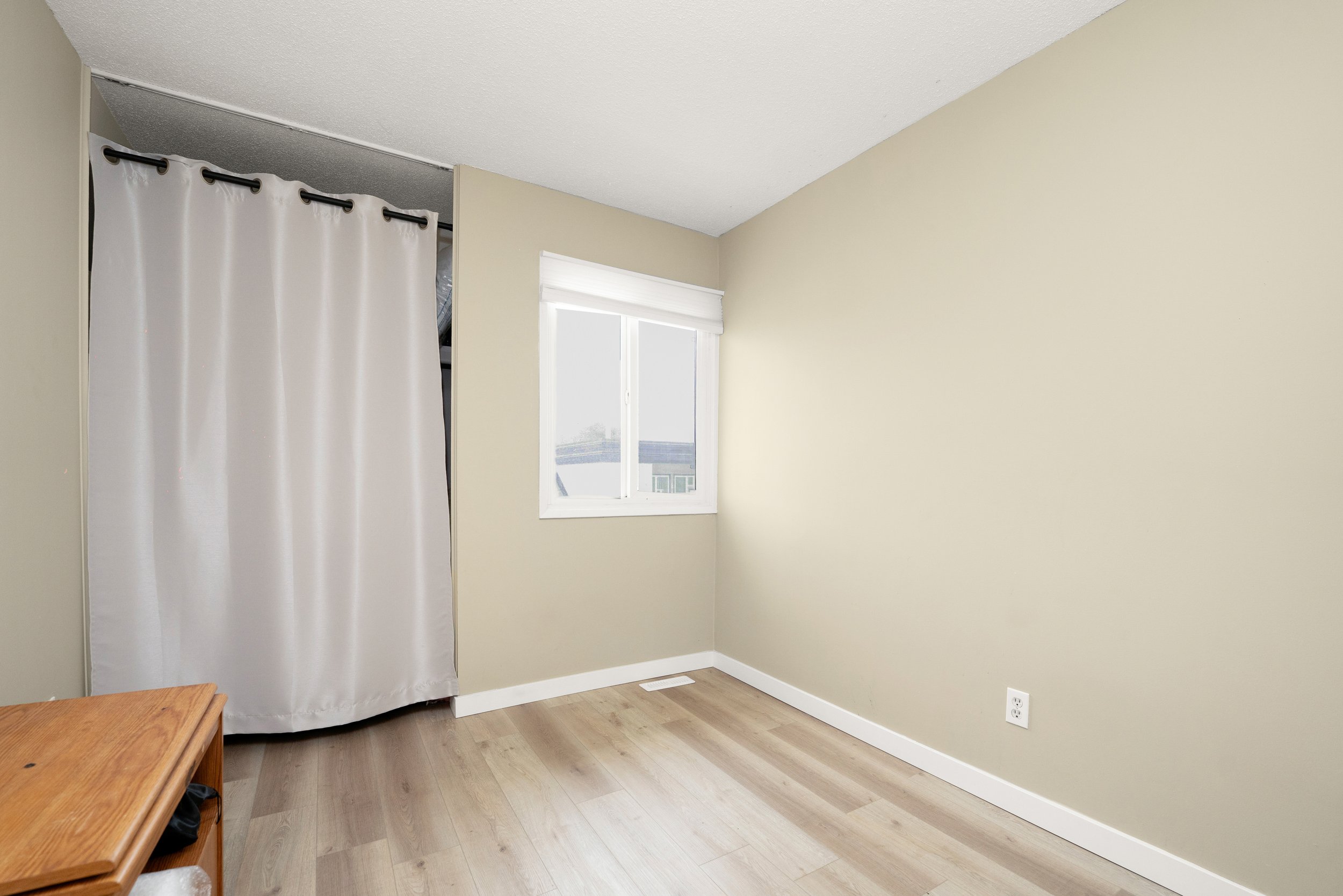 Bare room with a window and simple design.