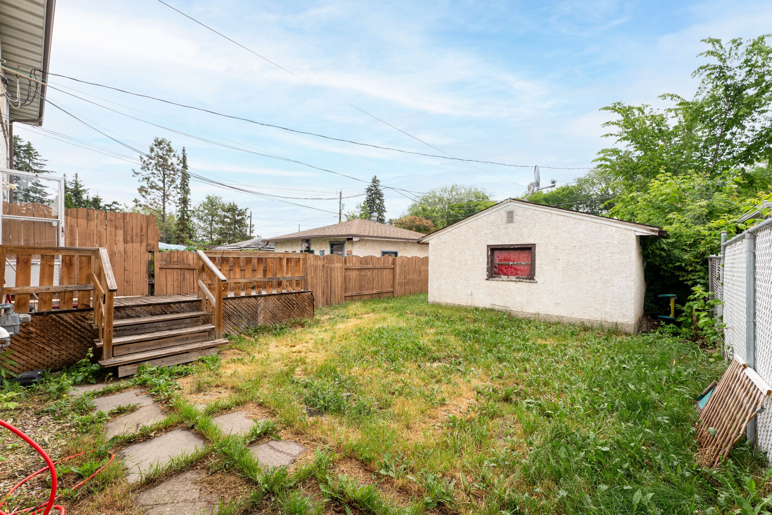 Well-maintained front lawn of a rent to own home with a charming house facade.