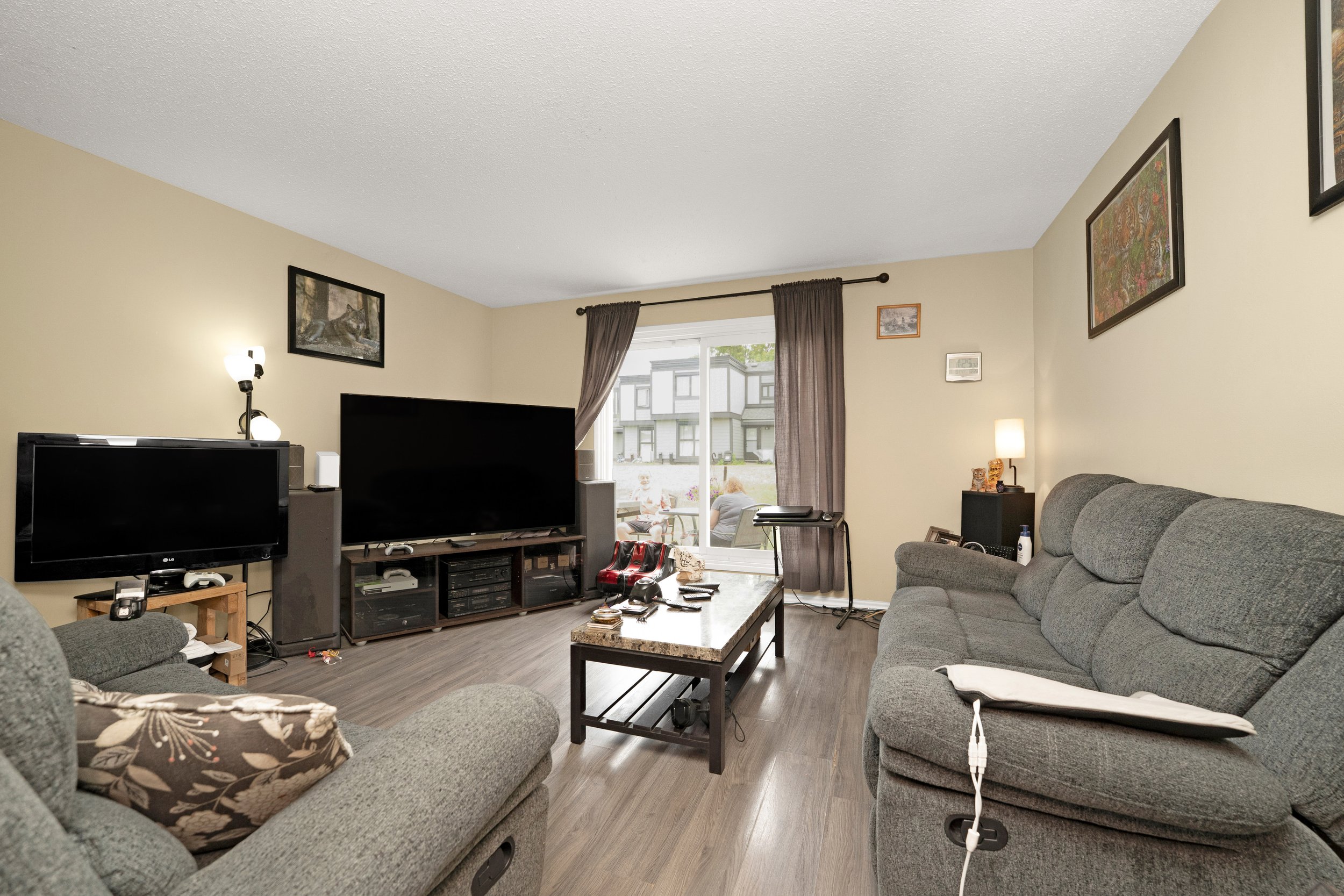 Cozy living area with modern furniture and hardwood floors.