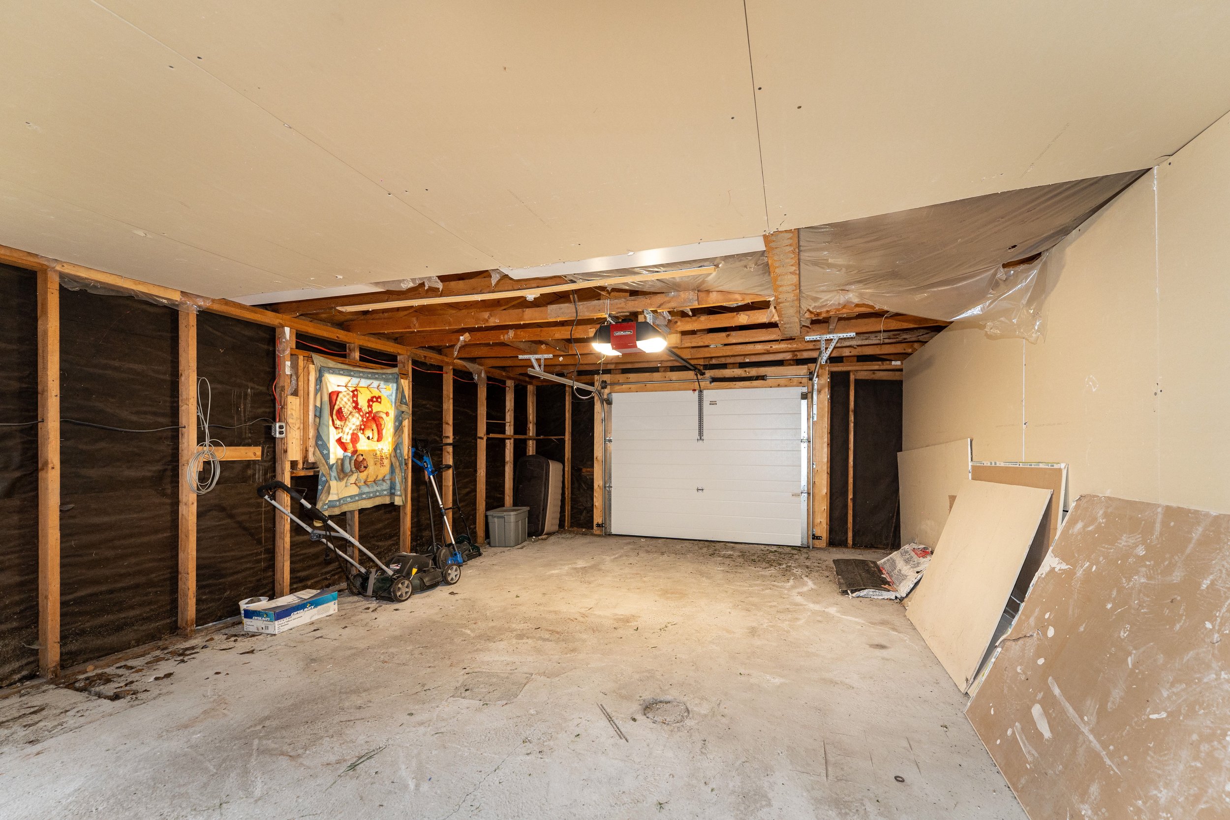 Spacious garage interior of a rent to own property, suitable for storage or workspace.