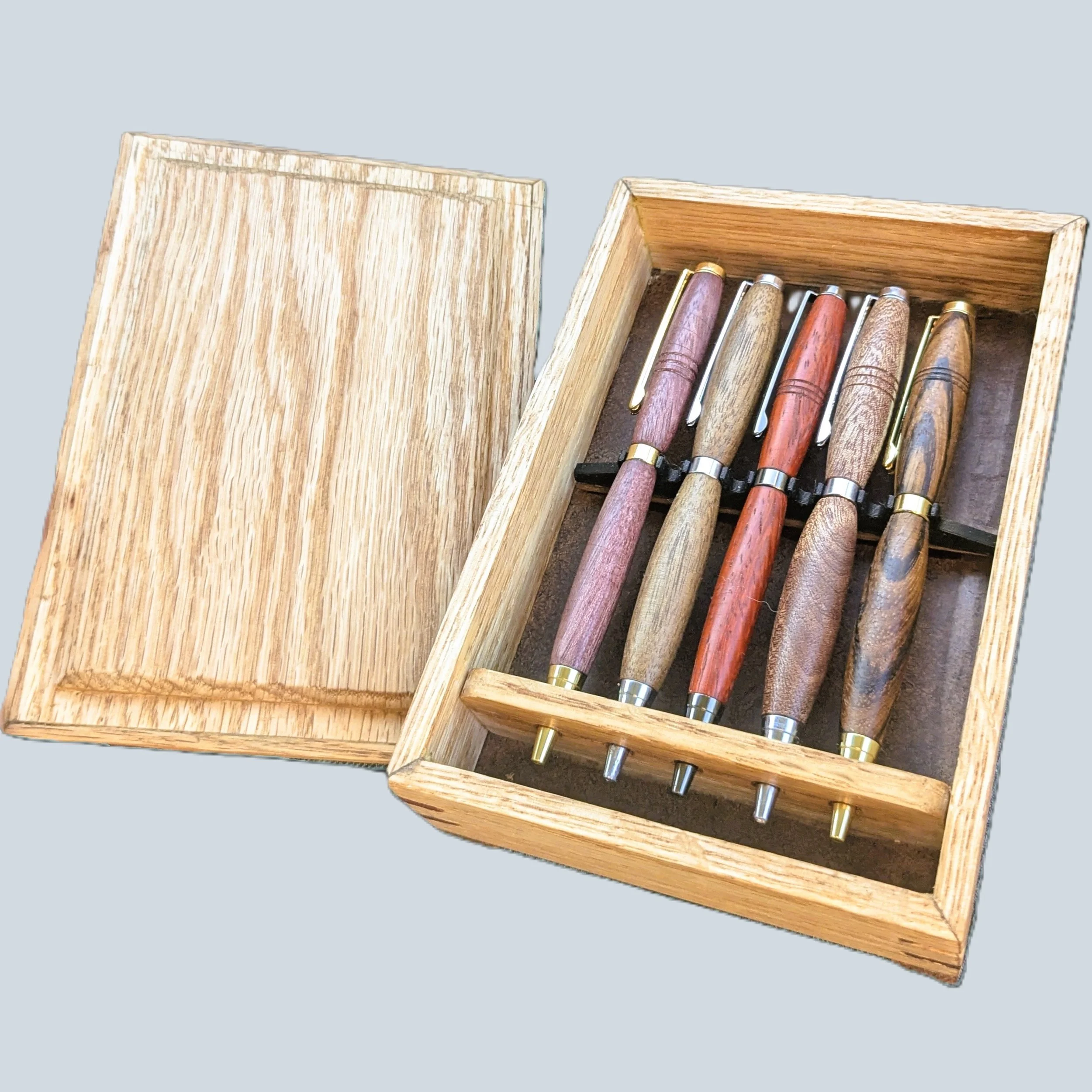 5-pen oak box with splined corners.  This was a Christmas gift, and the lid was made with chisels and a hand plane.