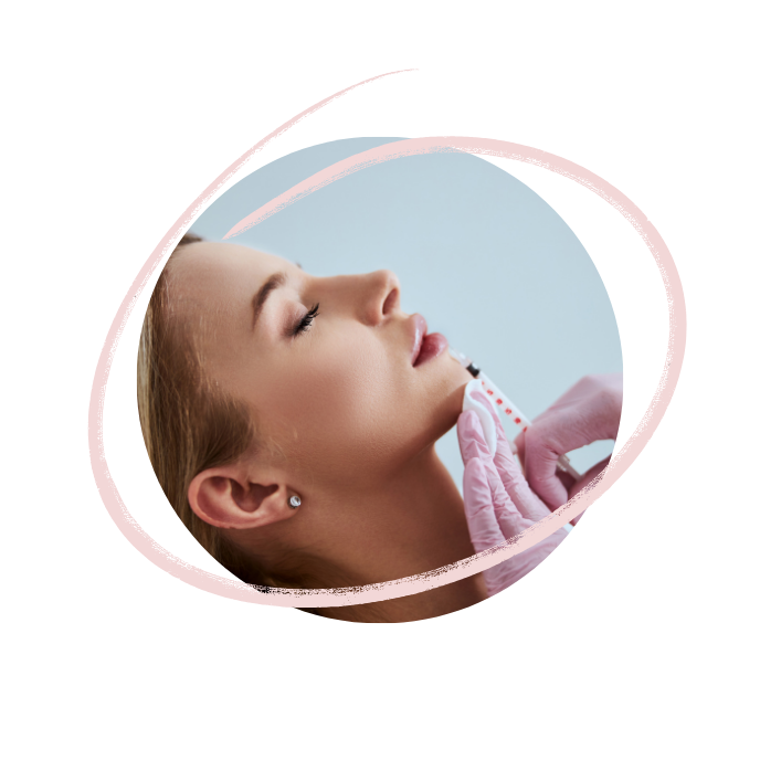 A woman with closed eyes receiving a beauty treatment with a brush and a practitioner wearing pink gloves.