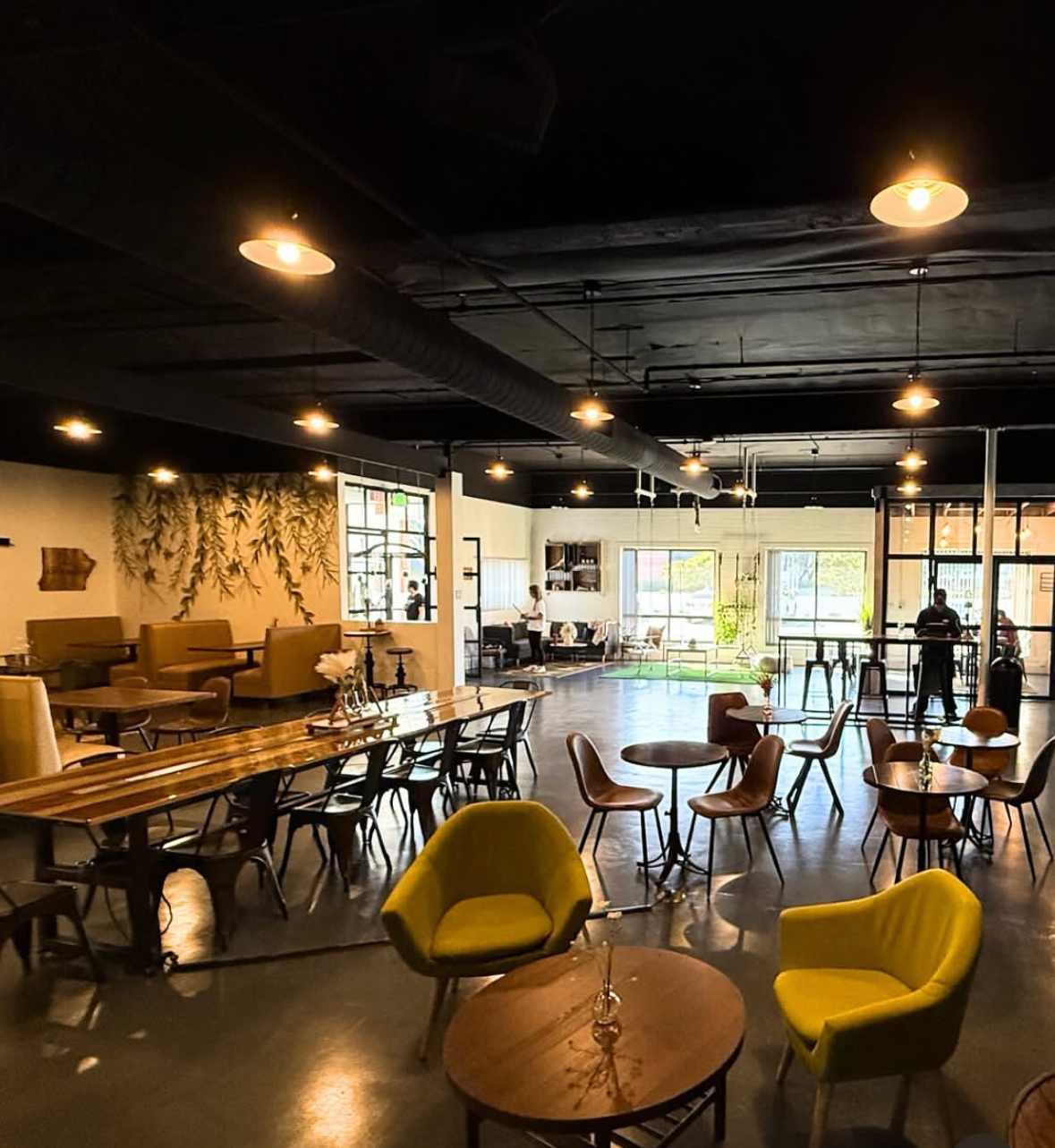 Interior of 'The Lab' various seating options including tables, chairs, yellow lounge chairs, and booth seating. 