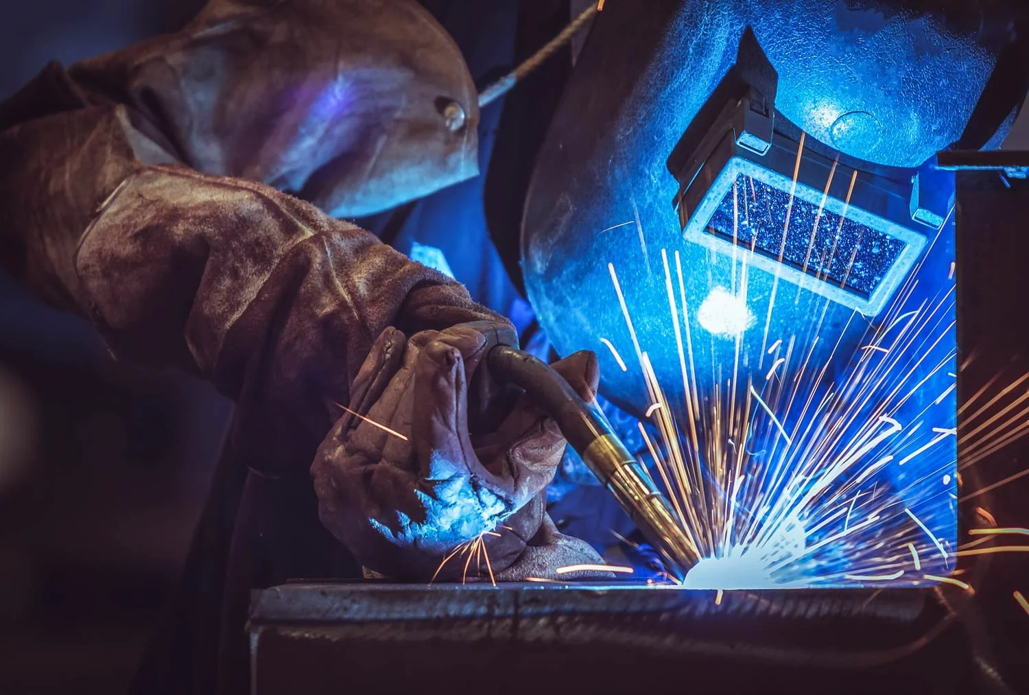close up of man in protective gear welding