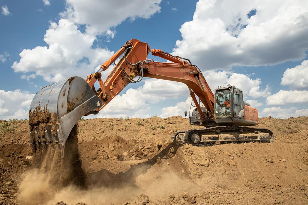 digger digging up dirt creating a lot of dust
