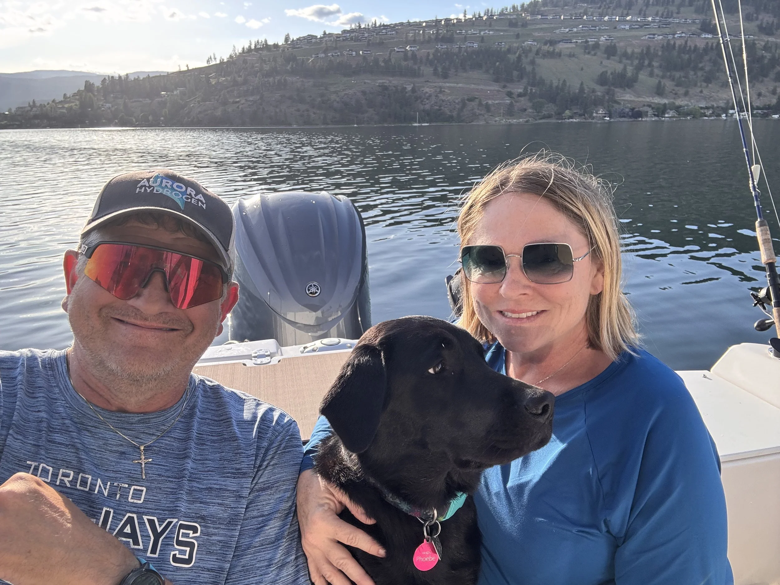 IAAD assistance dog enjoying a boat outing with handlers as part of everyday life and socialization.