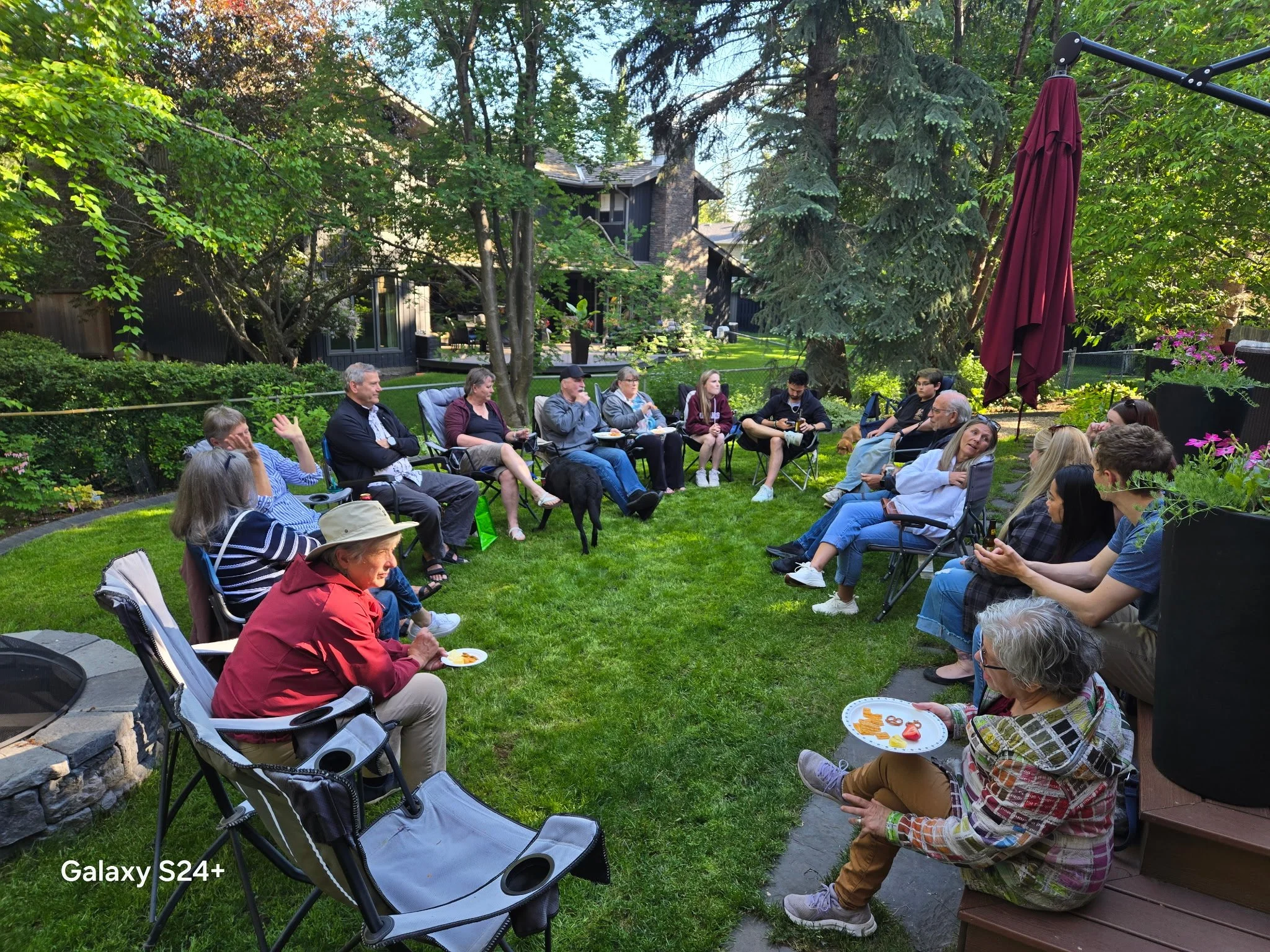 IAAD assistance dog community gathering with handlers, volunteers, and supporters outdoors.