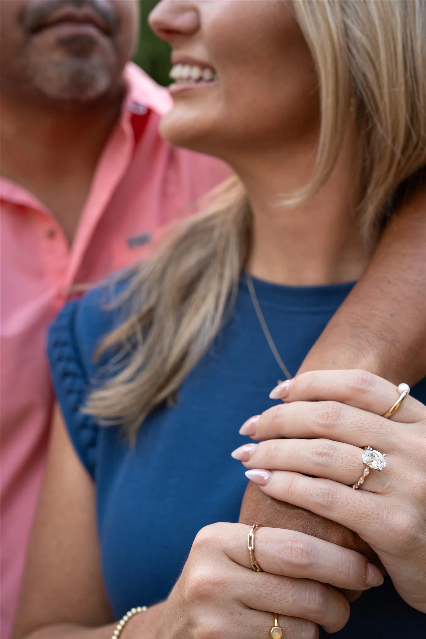 engaged couple smiling proudly diamond ring