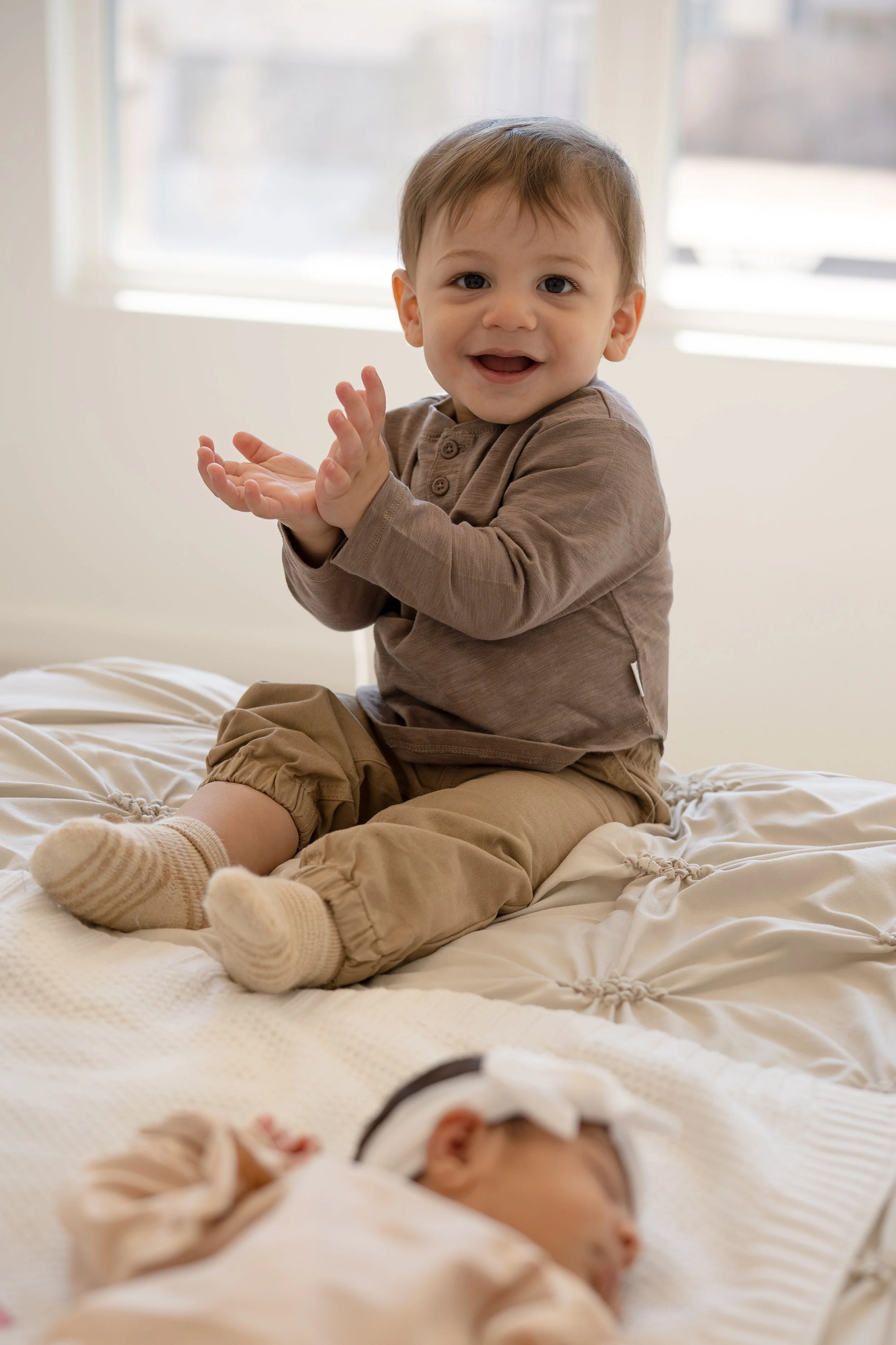 toddler boy playing near newborn baby in houston home